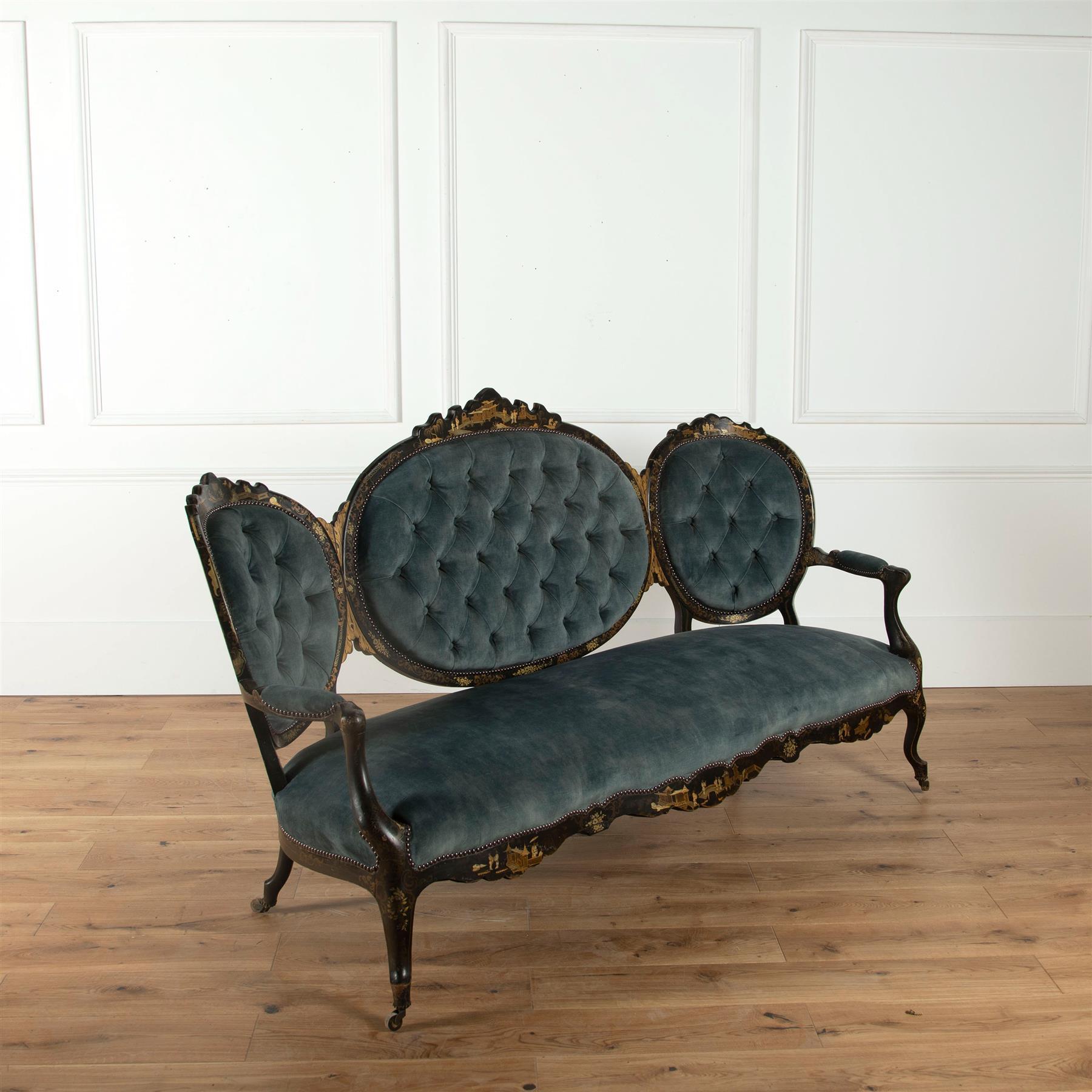 A stylish mid-19th century French chinoiserie salon settee of shapely form, with good quality gilt decoration to the seat back and frieze, featuring figures, buildings and foliage in a landscape. Newly upholstered in buttoned velvet.  Measures: Seat