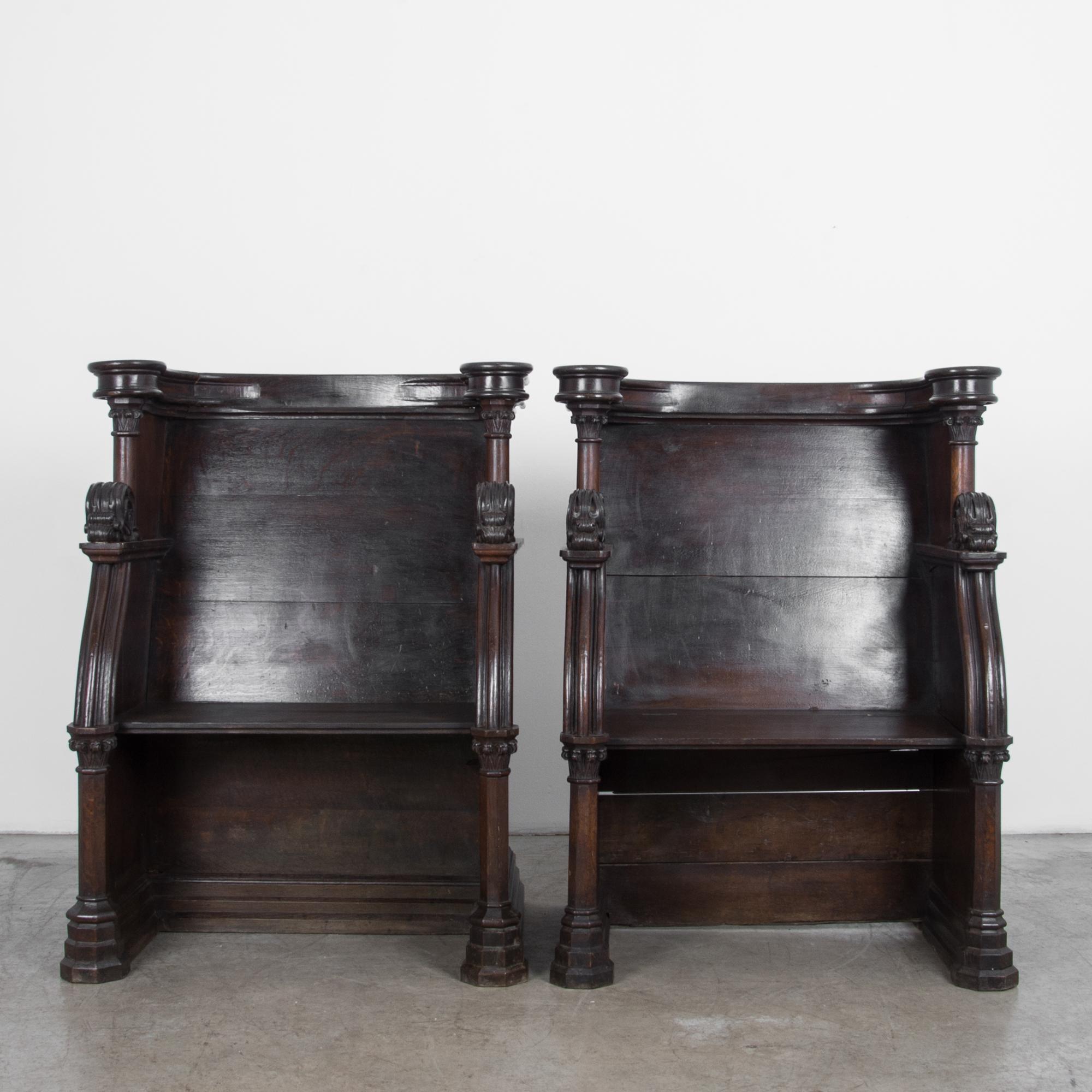 Two elegantly carved church benches from France, circa 1880. High quality construction in oak, with a traditional French polish. Details recall classical architecture, featuring a characteristic folding seat, and elegant moulding surround.
