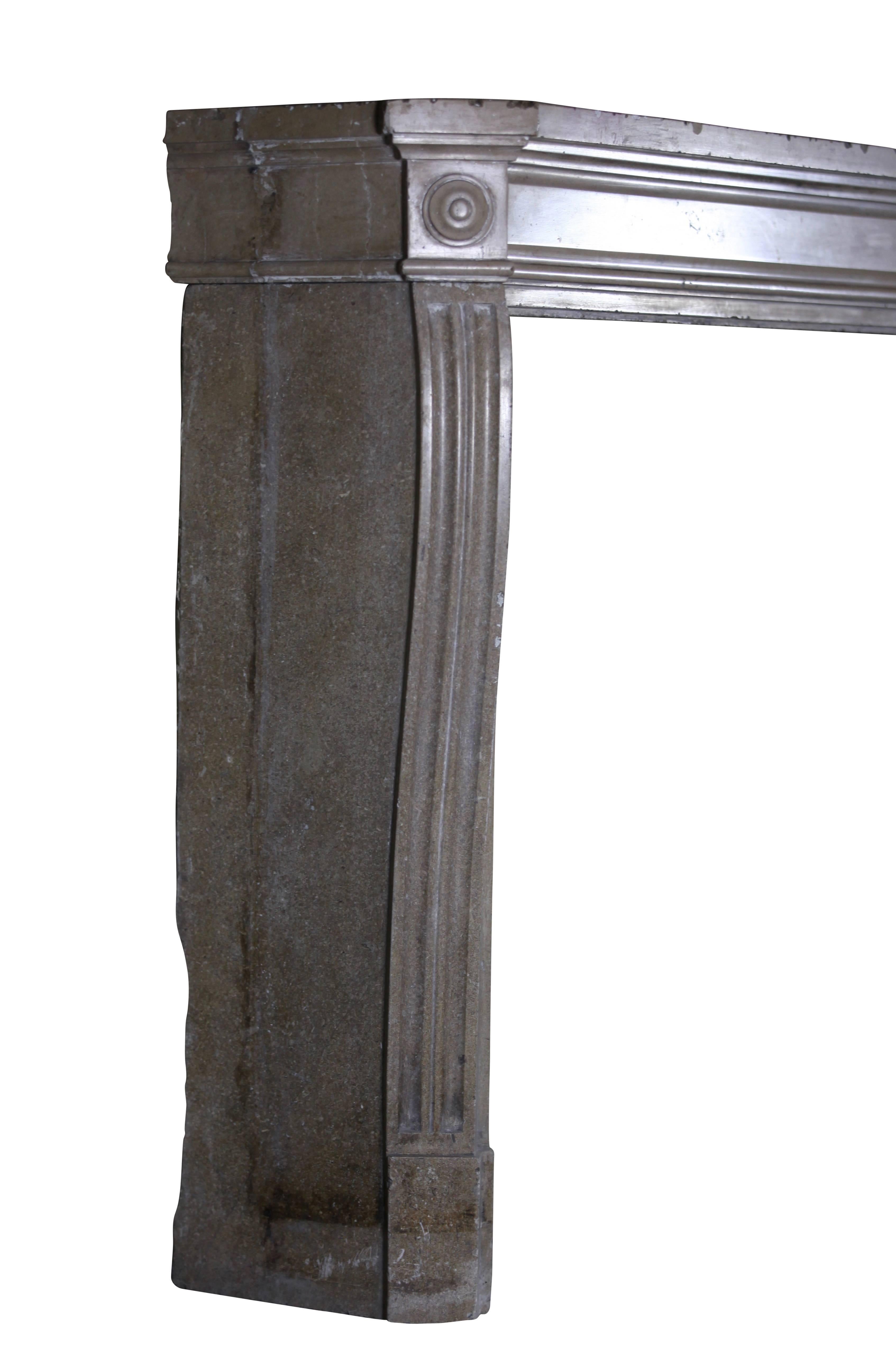 This is a beautiful antique fireplace surround in beige hard stone with bulls eye Has the looks of a marble one. It is perfect for a minimal timeless interior. 
Measures: 
142 cm EW 55.91