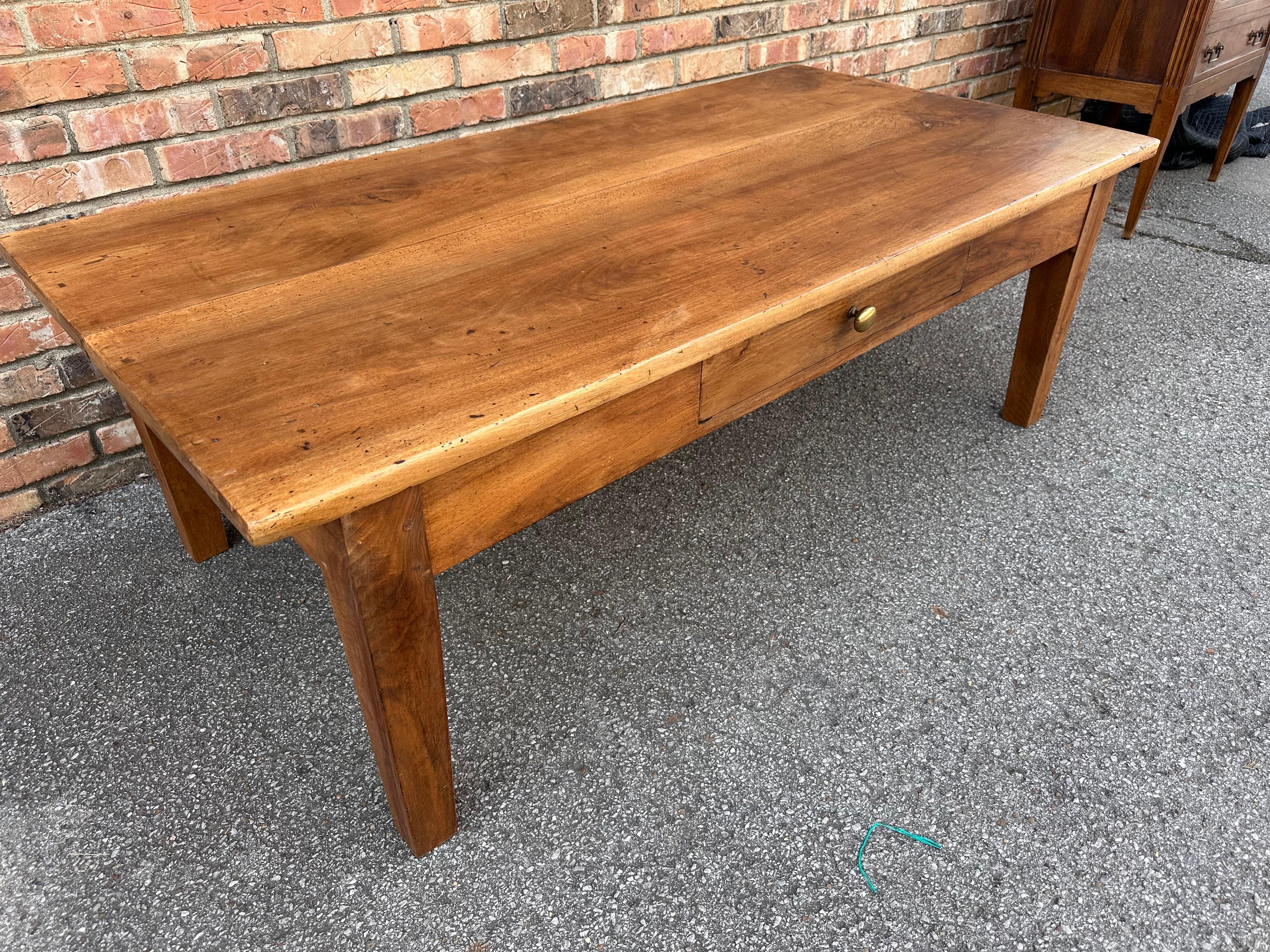 This is a beautiful mid 19th century French coffee table. The walnut wood gives it a nice warm tone and with such amazing patina. A single drawer to hold all the remotes we have to deal with these days. These tables are virtually indestructible