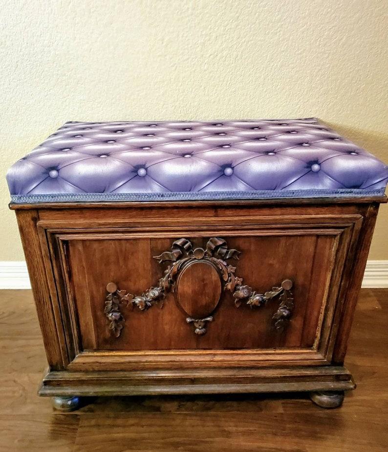 A unique, one of a kind, French antique oak coffer trunk from the late 19th century, now fashioned as a bench with later upholstery faux cushioned seat with printed three dimensional button tufting. 

The antique chest, circa 1875, having a hinged