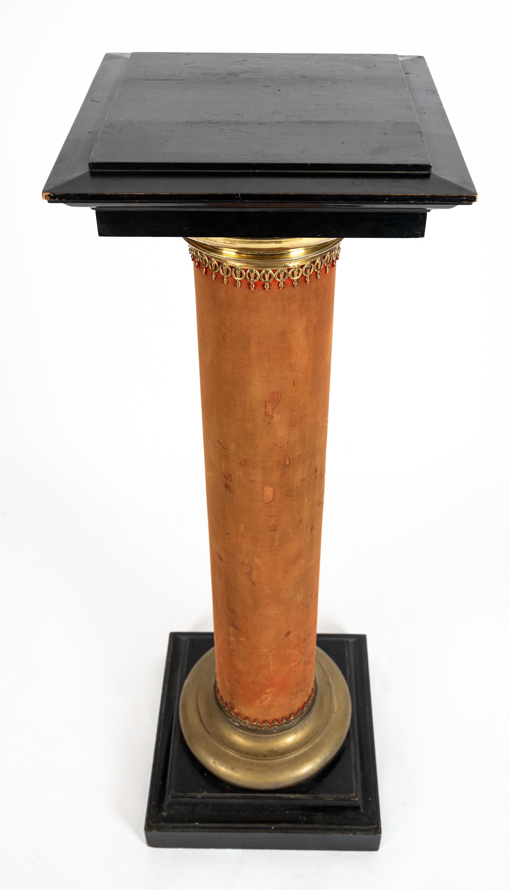 Late 19th century French column having ebonized wood on a square base and top. With worn red silk velvet, and bronze filigree on the top and bottom molded edges along the base of each column. circa 1880s.