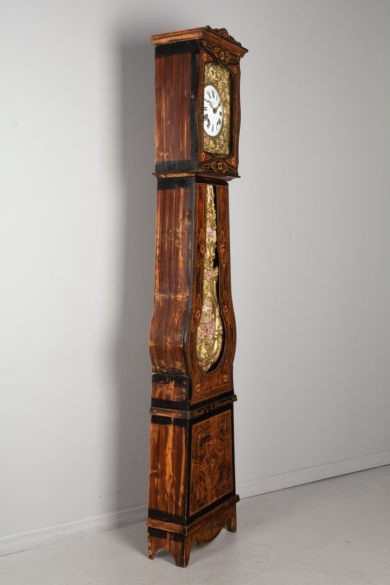 A beautiful 19th century country French comtoise, or grandfather clock, with polychrome painted pine case and embossed brass pendulum. Original seven day Morbier movement, professionally cleaned and in working order, with a gong chiming on the hour,