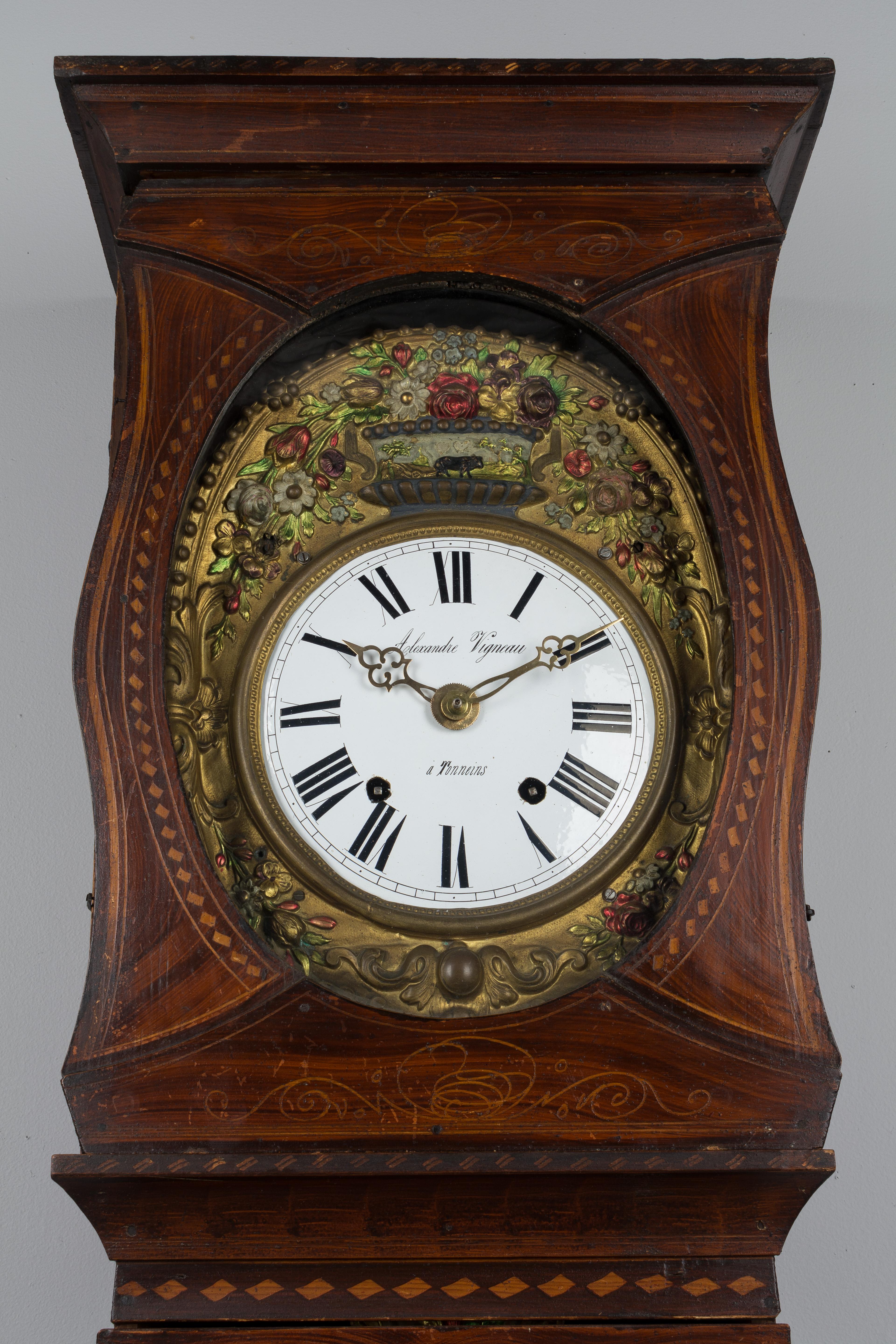 A good French country comtoise or grandfather clock with polychrome painted pine case and embossed pendulum. Original seven day Morbier movement, cleaned and in working order, having an enamel face, signed by the clockmaker, Alexandre Vigneau and