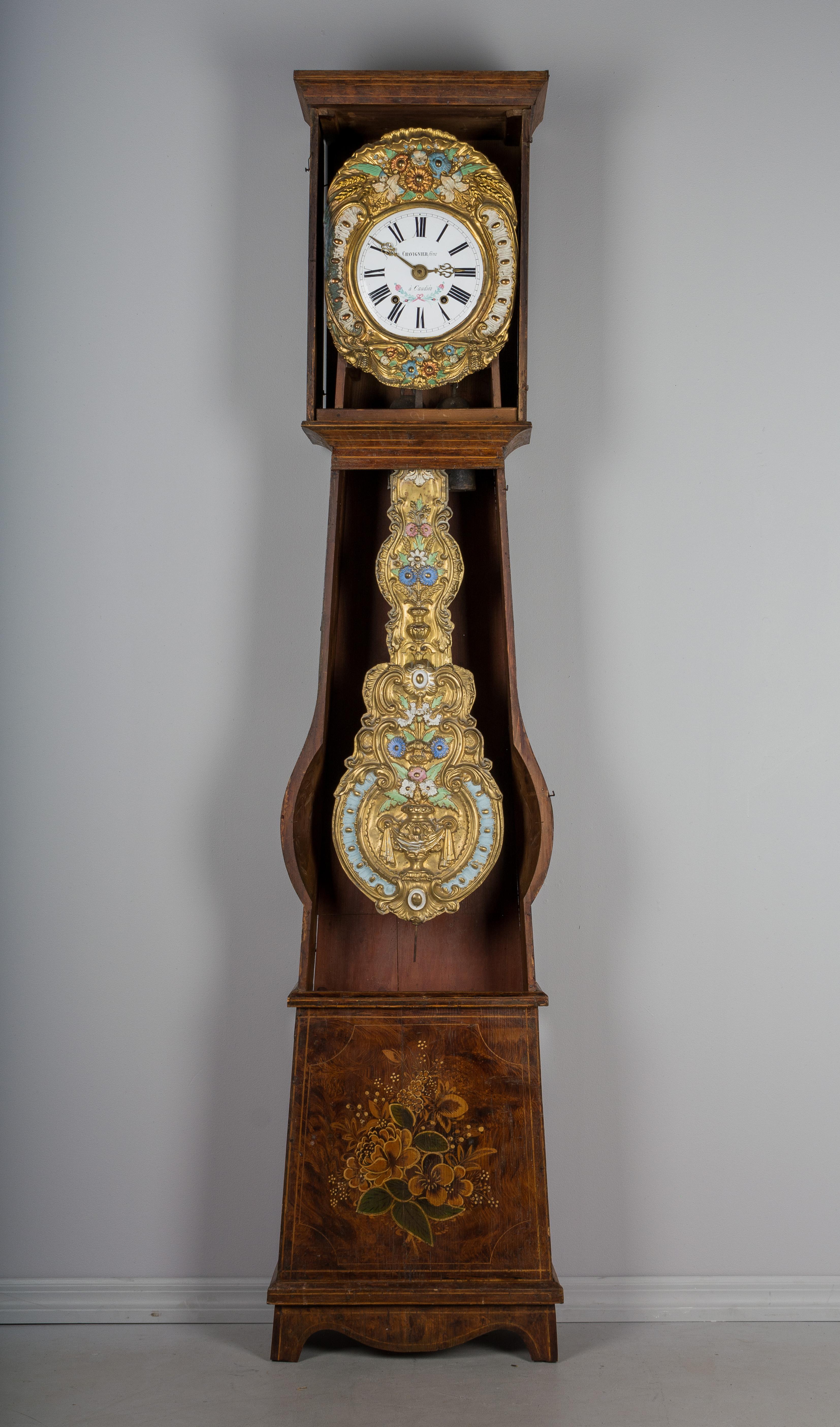 A 19th century Country French comtoise, or grandfather clock, with polychrome painted pine case and embossed brass pendulum. Original seven day Morbier movement, professionally cleaned and in working order, having an enamel face signed by the
