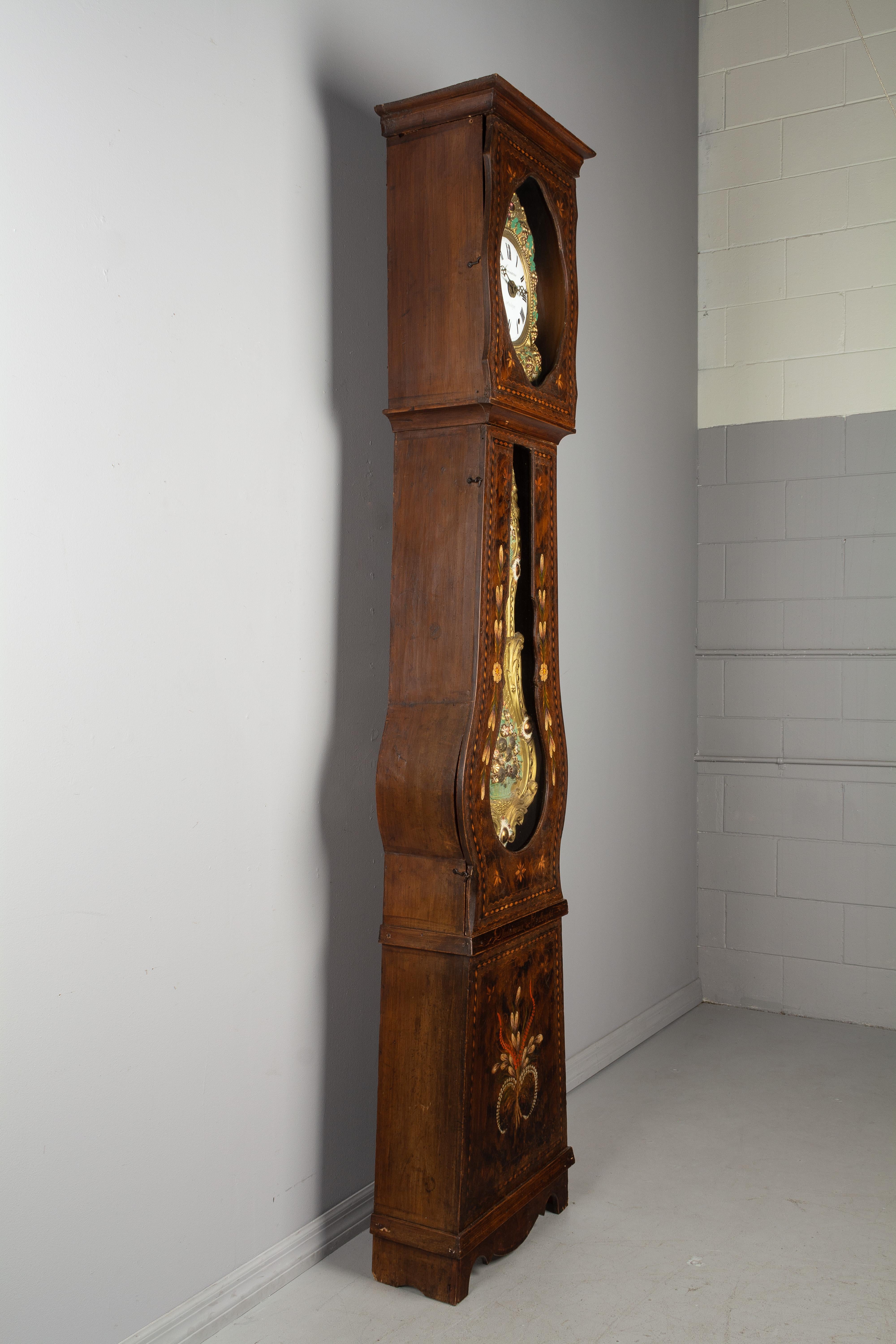 A beautiful 19th century country French comtoise, or grandfather clock, with polychrome painted pine case and embossed brass pendulum. Original seven day Morbier movement, professionally cleaned and in working order, with a bell chiming on the hour,