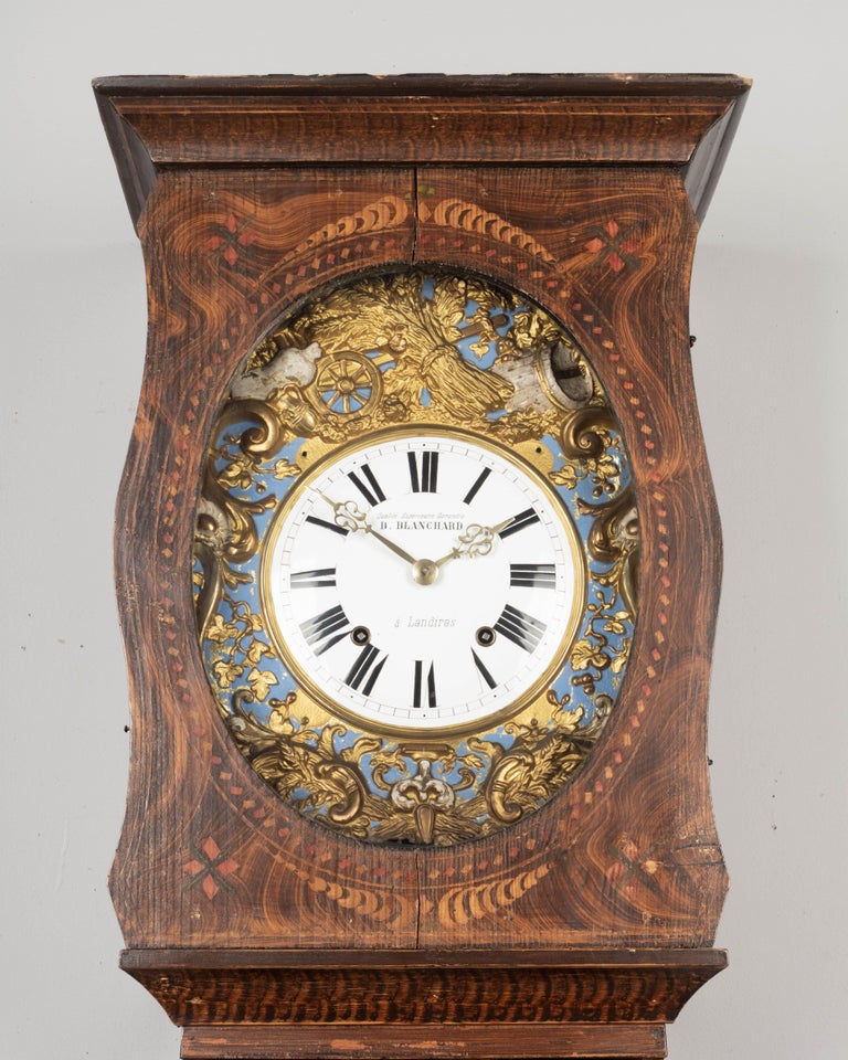 A French Country comtoise, or grandfather clock, with polychrome painted pine case and embossed brass pendulum. Original seven day Morbier movement, professionally cleaned and in working order, having an enamel face signed by the clockmaker, B.