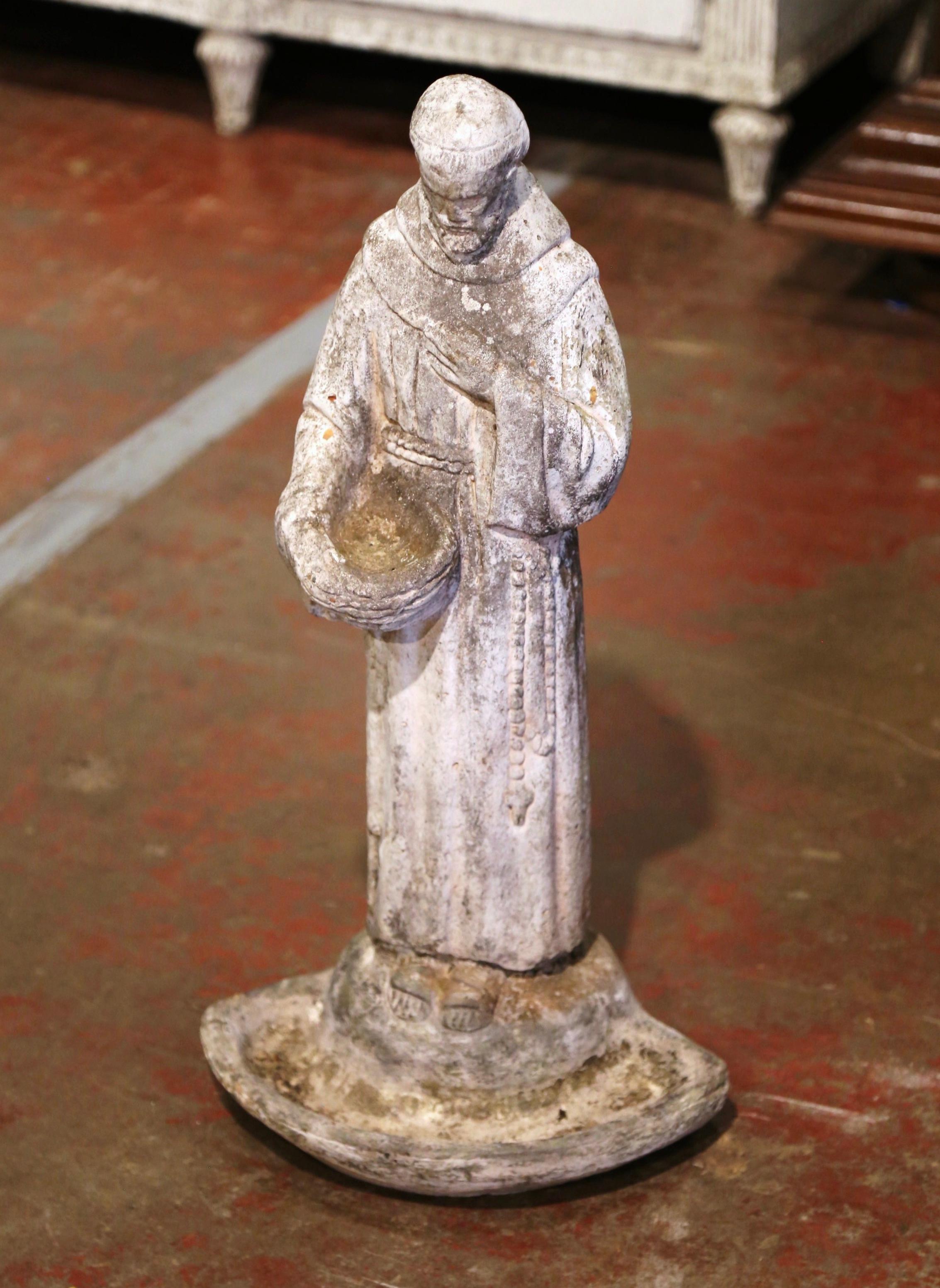 Decorate an outdoor garden with this antique bird bath statue featuring Saint Francis, the saint patron of animals. Crafted in France circa 1880, the carved statue depicts the Saint dressed in cassock, holding a bowl to feed the birds. The garden