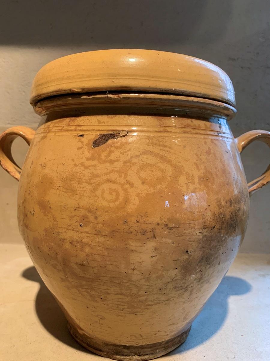 A good 19th century ocre glazed Confit Pot from the South of France. In good condition, normal small hairline cracks and signs of domestic use. With the original lid and a beautiful faded decoration on one side.