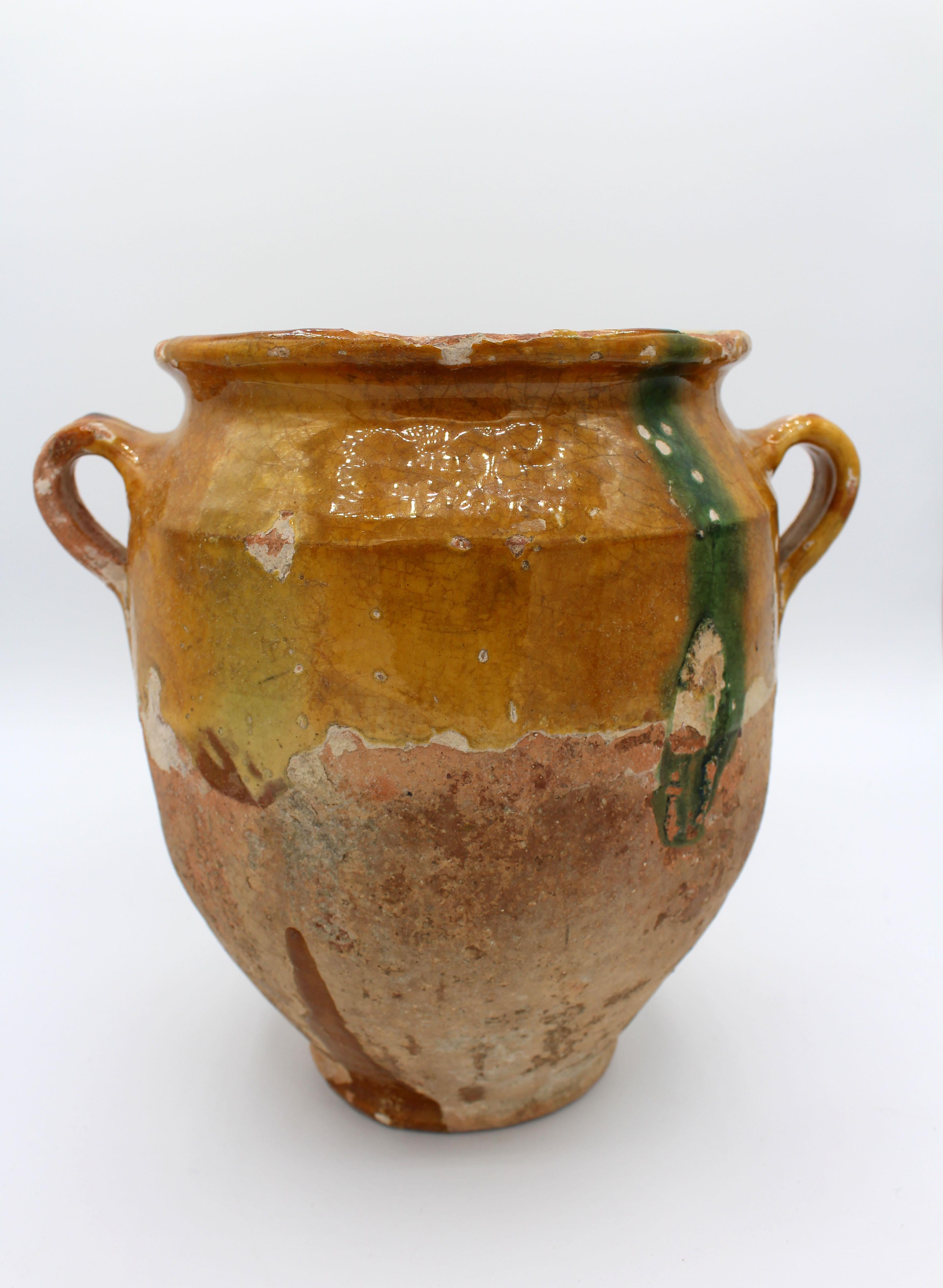 19th Century French confit pot. In traditional yellow to ochre glazed terra cotta with a green glaze line. Typical chips and glaze losses. 10