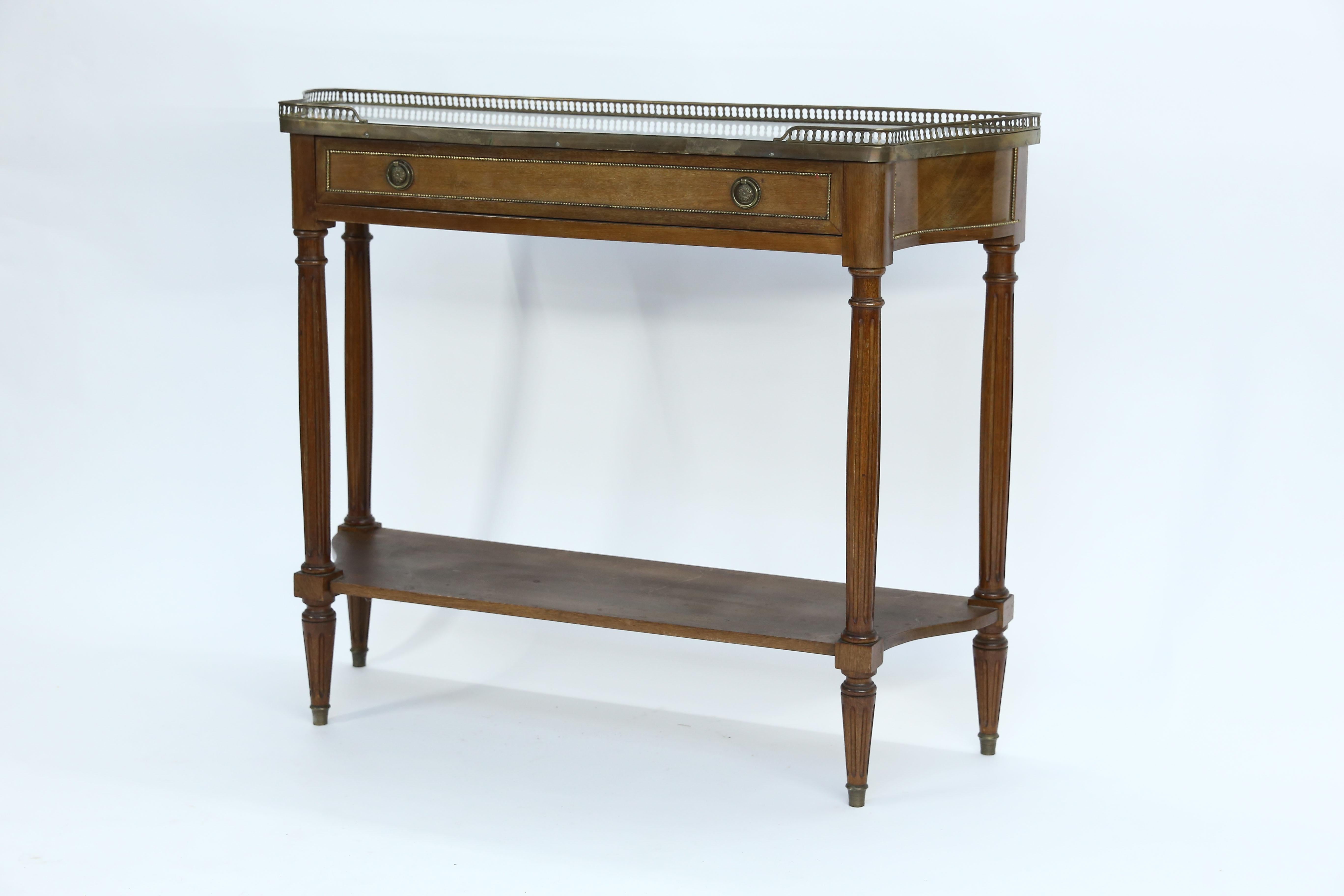 Beautiful 19th century French console with a raised brass gallery and Carrara marble top. This console has one drawer and one shelf.