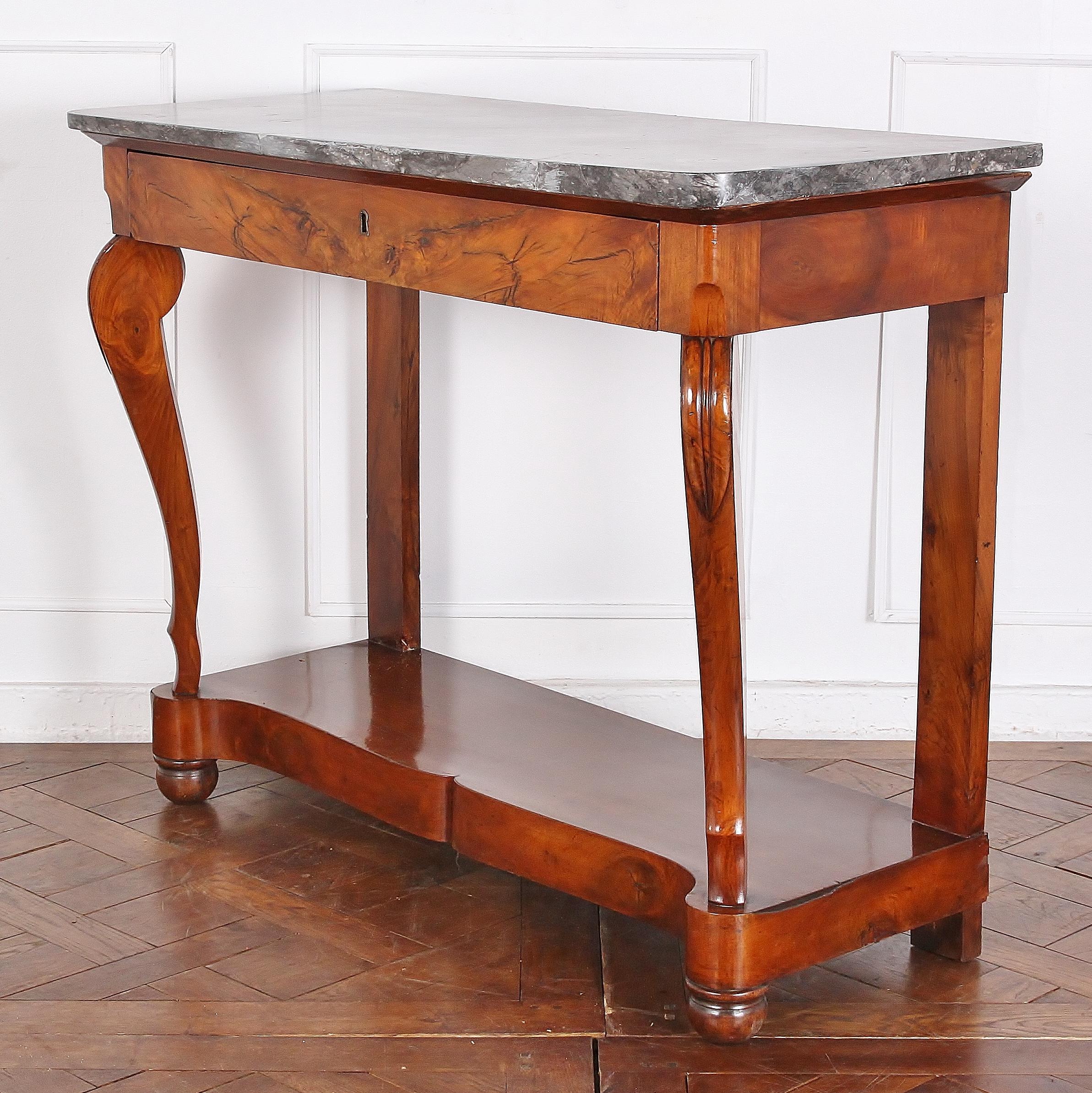 19th century French Empire walnut and marble top console having a single drawer fitted below the marble, the top raised on scroll supports and a simple plinth base, circa 1840.