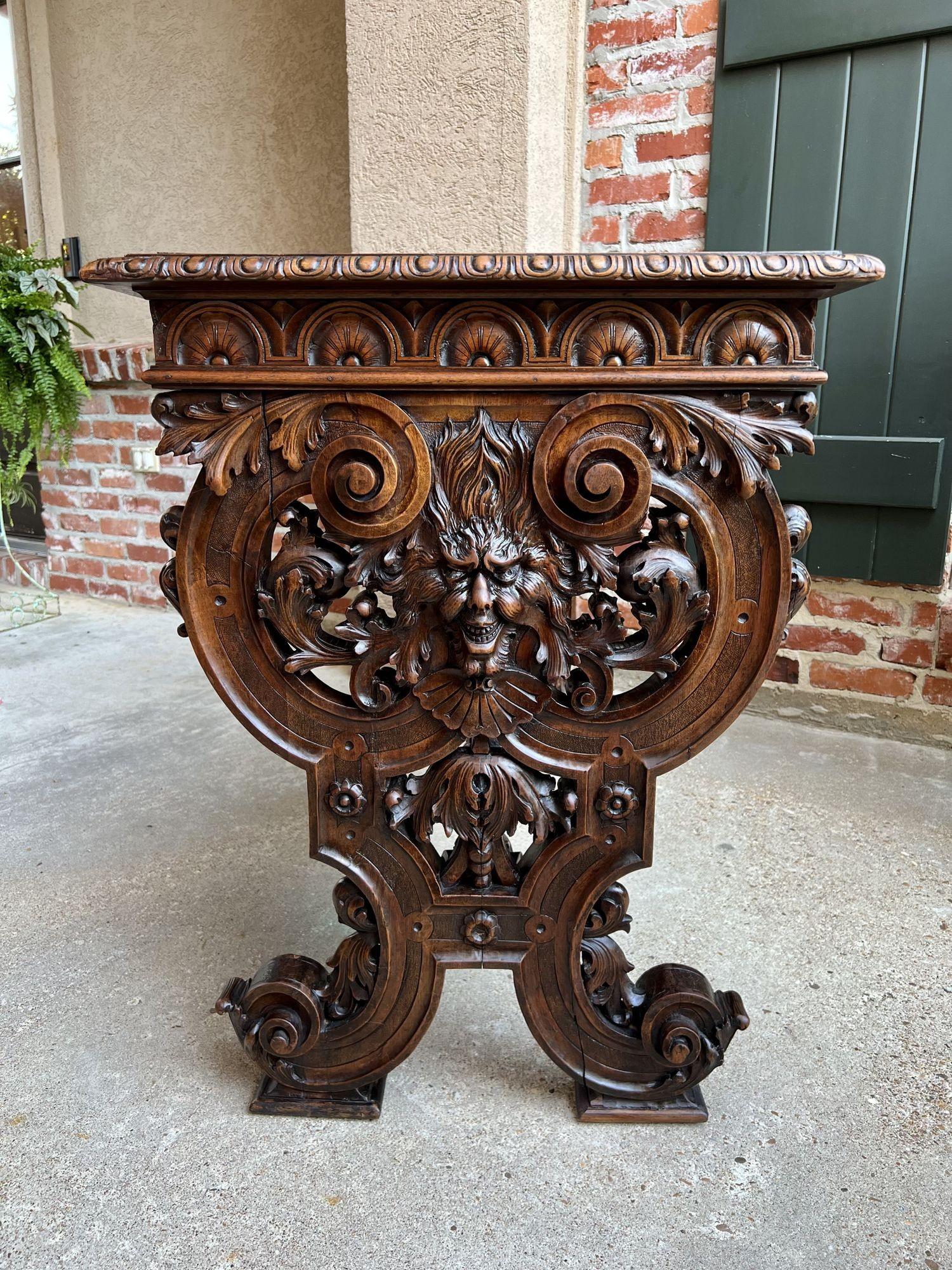 19th Century French console sofa table Louis XIV style carved walnut w Lyre Scrolls.
 
Direct from France, a highly carved 19th century sofa table, opulently carved on both the exterior and interior sides of the trestle legs.
Carvings of scrolls and