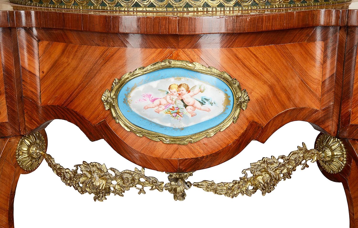 A good quality 19th century French Kingwood jardinière, having gilded ormolu mounts and swags, Sevres style porcelain plaques and raised on elegant scrolling cabriole legs.