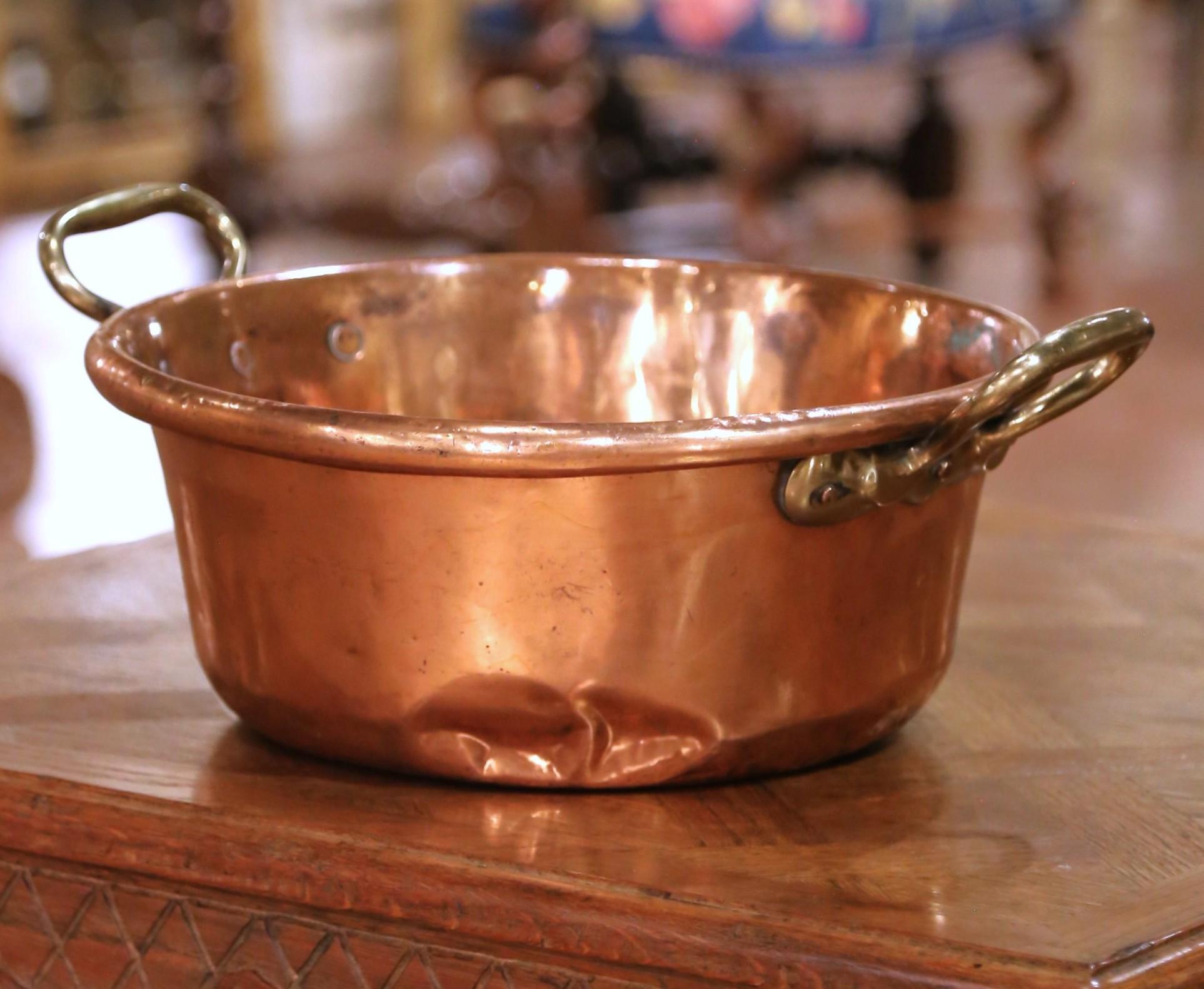 Bring a touch of authentic French countryside charm to your kitchen with this large 19th-century copper marmalade bowl. Crafted in Normandy, France circa 1880, this traditional bassine à confiture (jam pan) features a classic round form with two