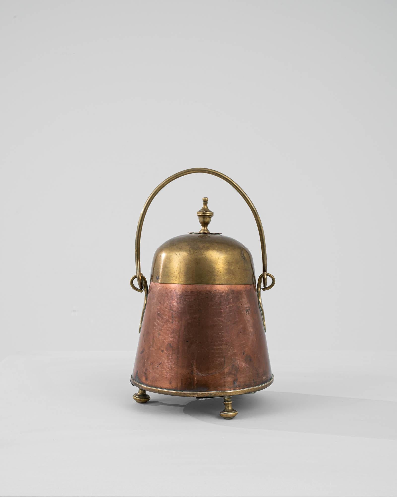 Transport yourself to the 19th century with this antique French Copper and Brass Pot, reminiscent of a Dutch 'doofpot.' Originally designed to store unburned wood or other fuel, these pots played a crucial role in preventing fires in medieval Dutch