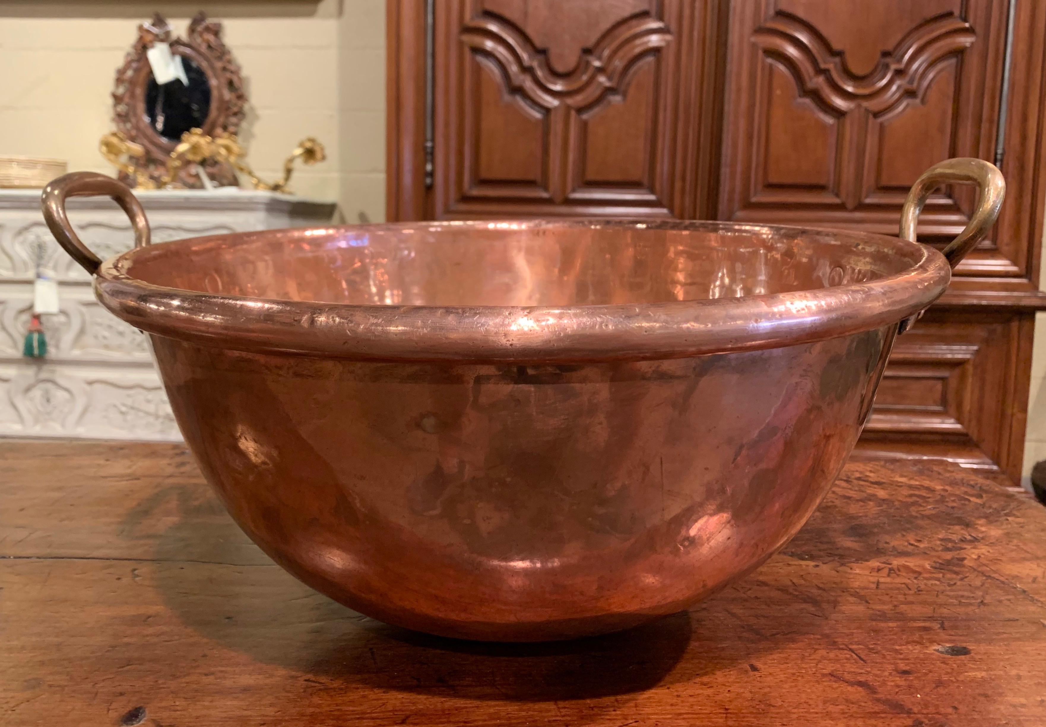 Keep your wine or beer chilled in style with this large elegant round bowl; crafted in Northern France circa 1870 and originally used for homemade jelly, the circular copper bowl is dressed with bronze side handles attached with rivets over a