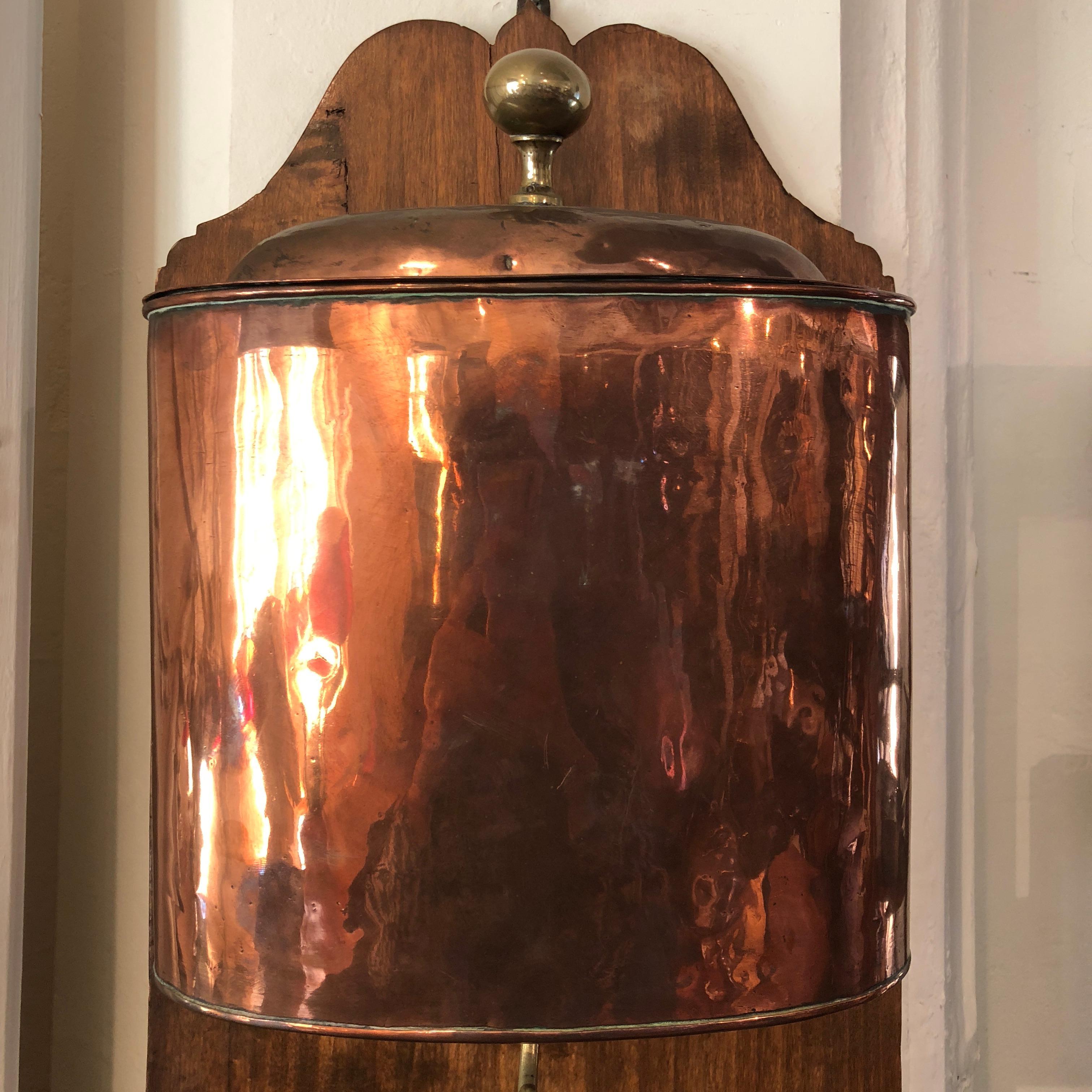 This splendid early 19th century French copper Lavabo (hand washer), has been mounted on a French oak plaque and features an all copper cistern and basin and a brass spigot. This stunning, collectable piece can be mounted as a decorative feature in
