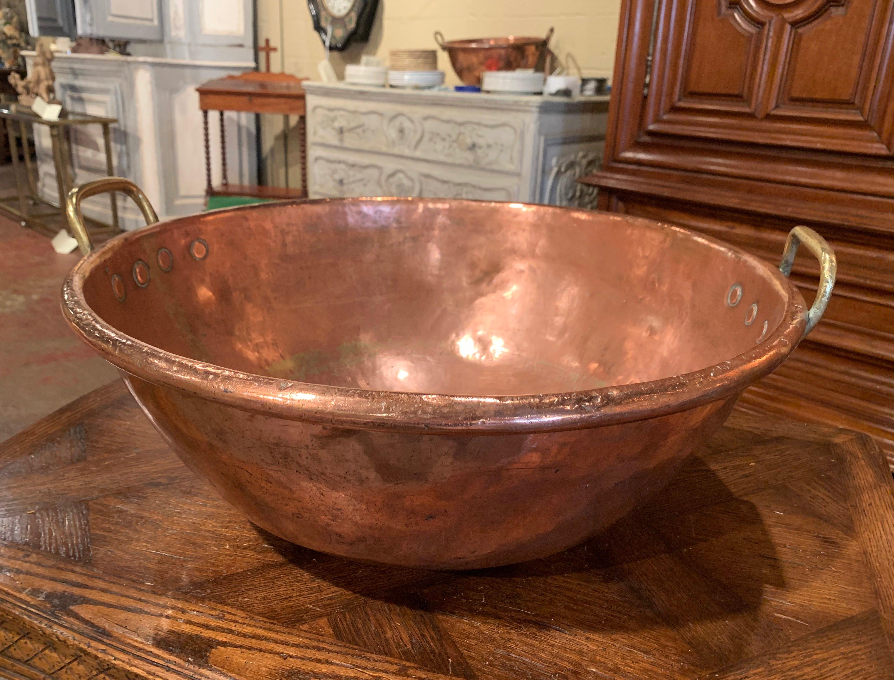 Keep your wine or beer chilled in style with this large elegant round bowl; crafted in Northern France circa 1870 and originally used for homemade jelly, the circular copper bowl with rounded rim is dressed with brass side handles attached with