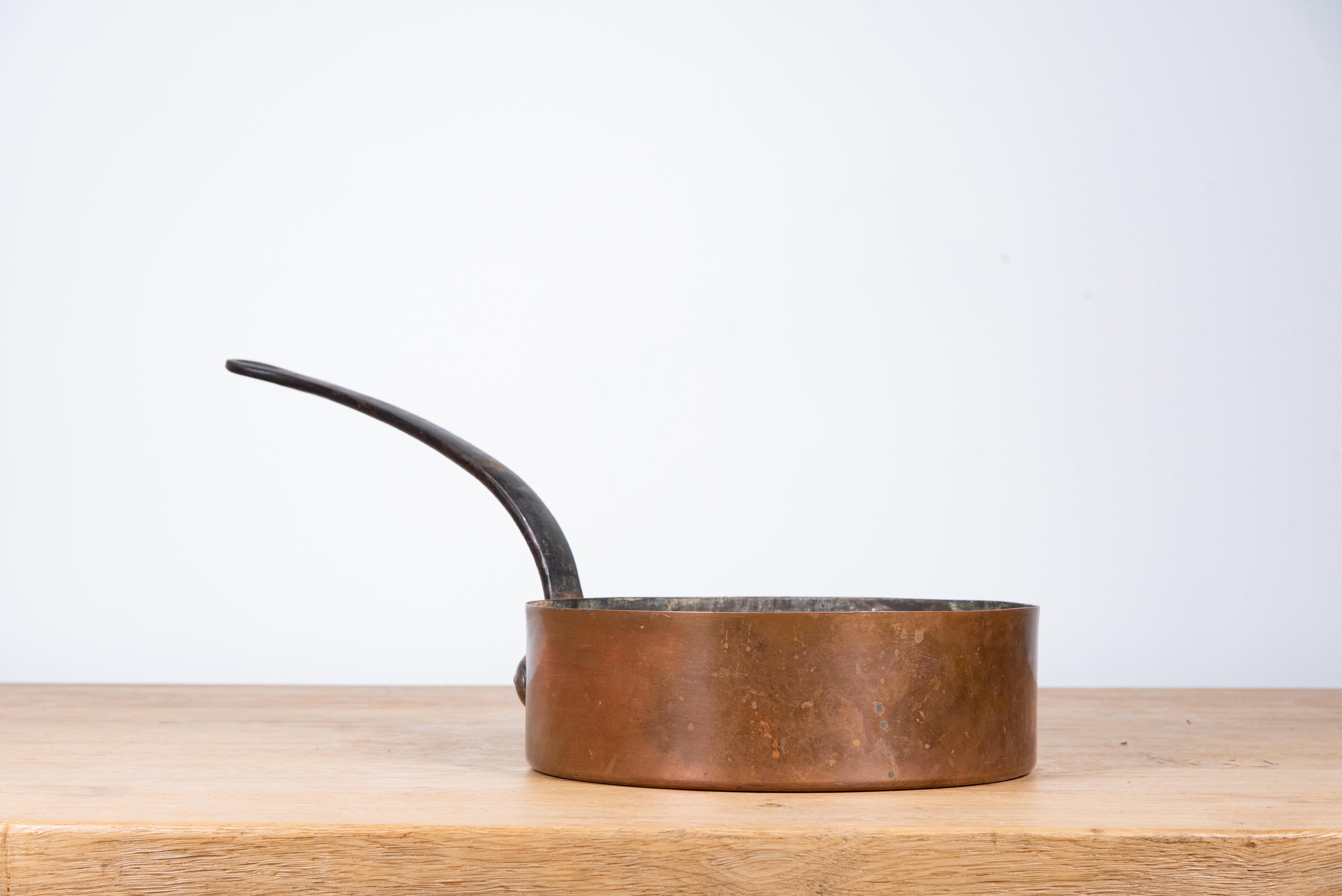 This 19th Century French Copper Pan from Serrant is a stunning example of traditional French craftsmanship. Handcrafted with durable copper, this pan showcases a rich patina developed over time, adding to its unique character and charm. The pan’s