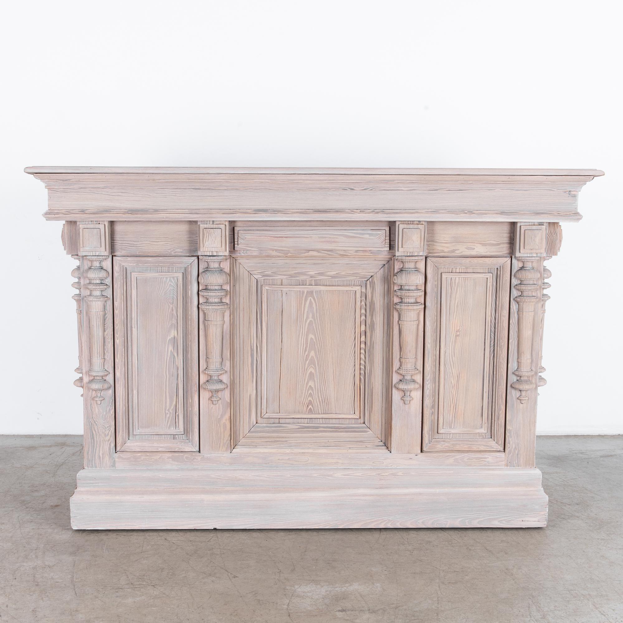 An intriguing French Country style bar from France, circa 1880. A rustic construction technique reflects the casual yet refined aesthetic of French provincial furniture makers, featuring intriguing architectural mouldings. Wooden turned ornaments