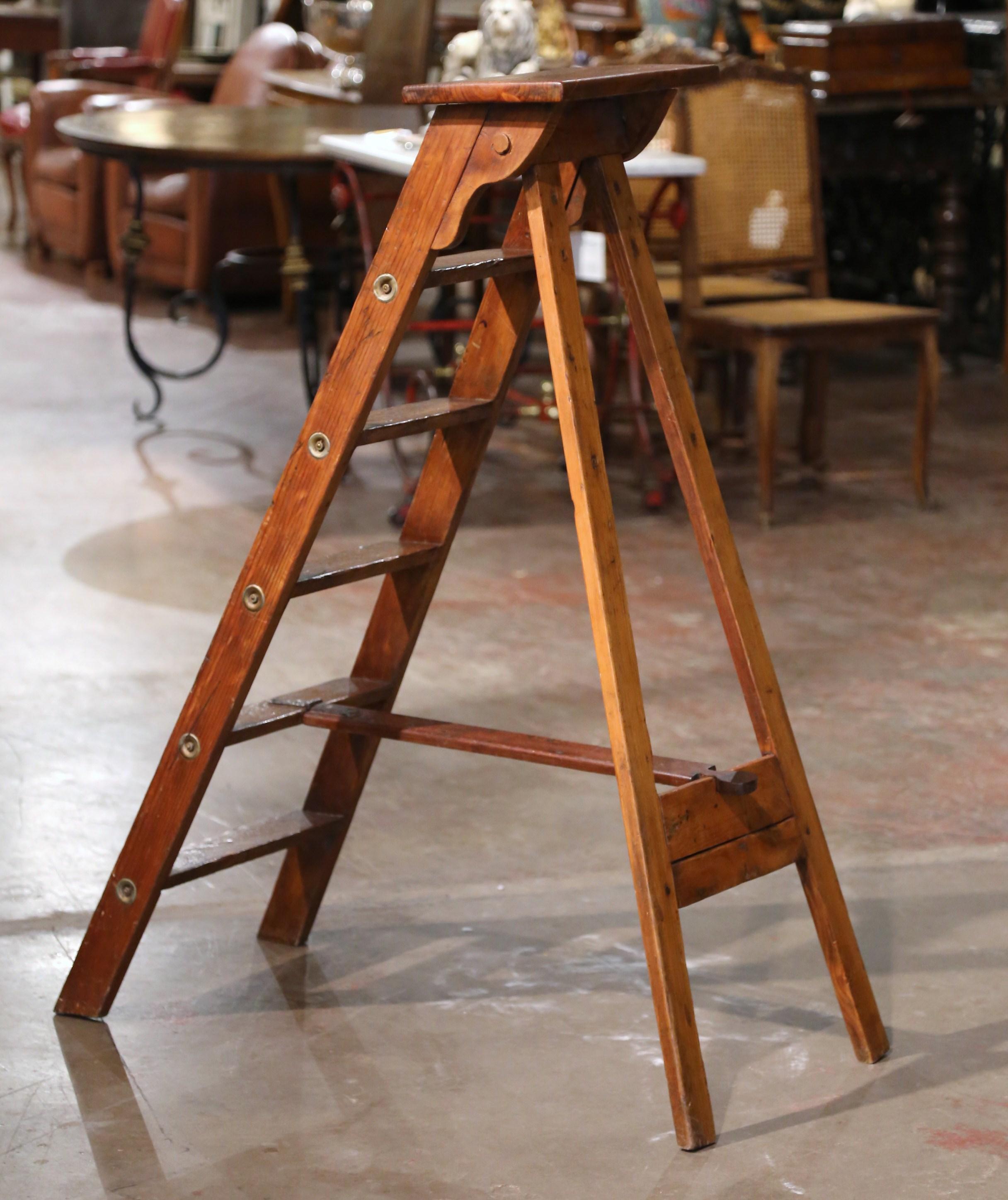 Decorate a study or a library with this whimsical antique ladder. Crafted in Lyon, France circa 1880 and made of pine, the sturdy step ladder features six steps including a wider and deeper step at the top. Practical and useful, the rustic ladder