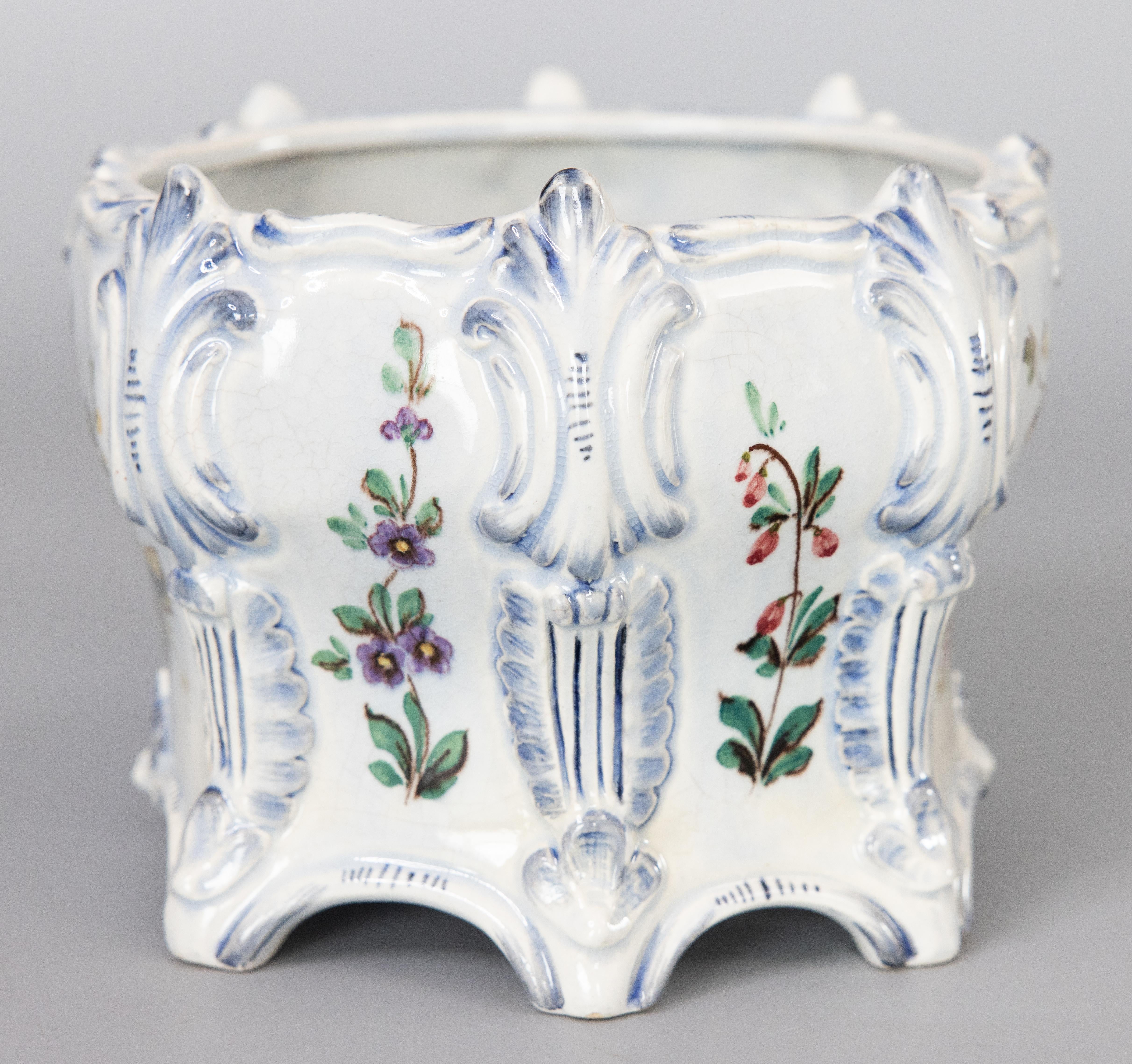 A lovely antique French floral faience hand painted jardiniere / cachepot / planter. Maker's mark on reverse. It would be gorgeous displayed with your favorite plant or with decorative items.

DIMENSIONS
7.5
