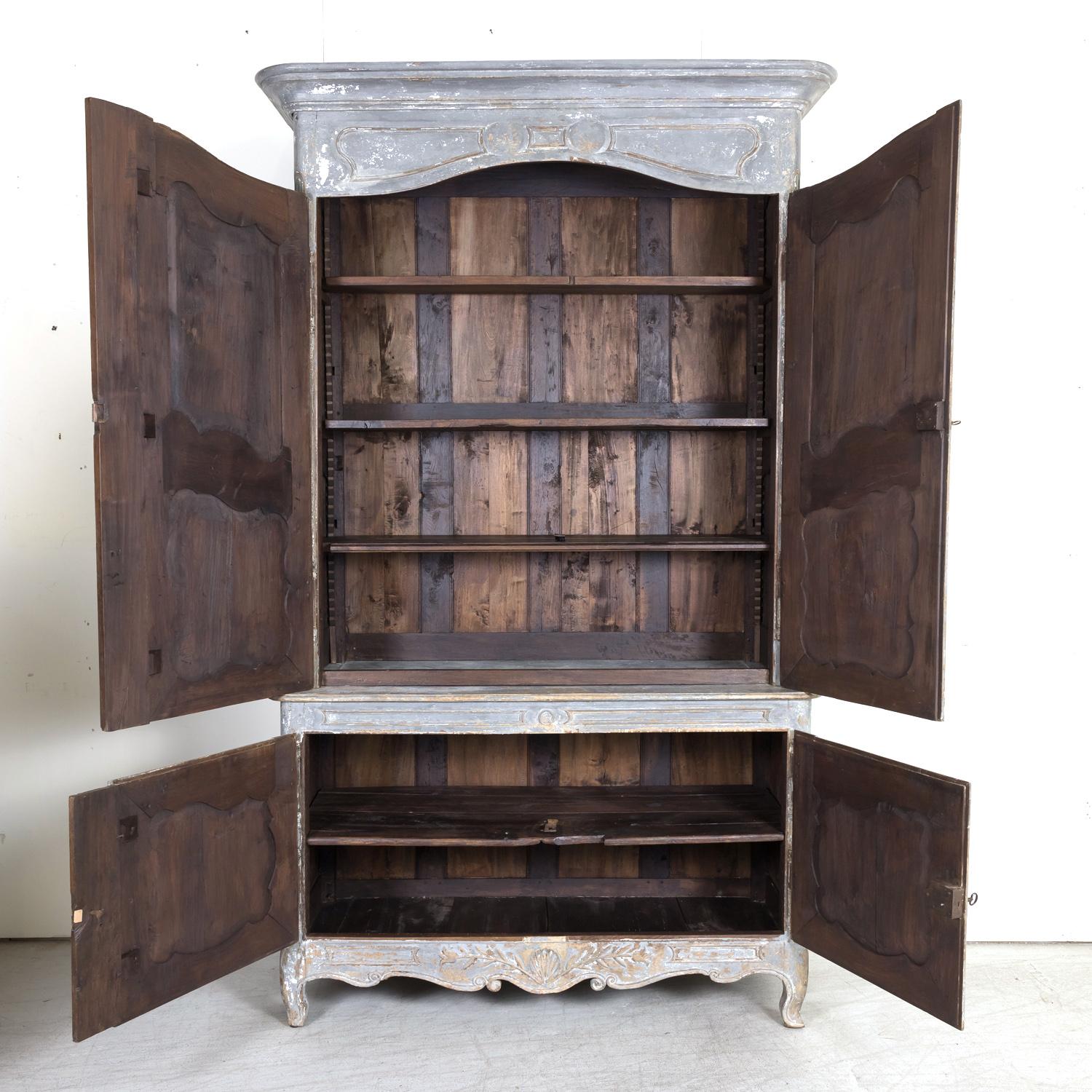 A superb 19th century French Country Louis XV style painted walnut chateau buffet à deux corps handcrafted in walnut by a highly skilled ébéniste in Provence with a beautiful bluish gray painted finish showing some wood, circa 1850s. Crowned with a