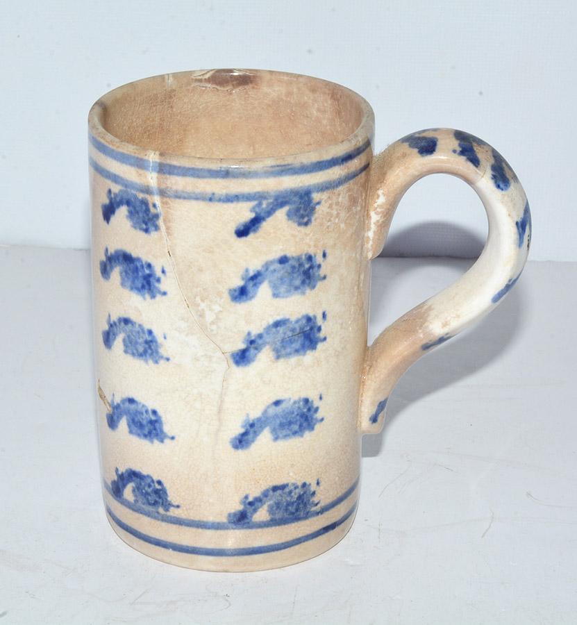 Very rare and early 19th century, possibly earlier French stoneware pottery mug has a blue spatter design under glaze on the sides and handle. The number 100 is printed on the side as well. Pairs of blue rings found on top and bottom. Although there