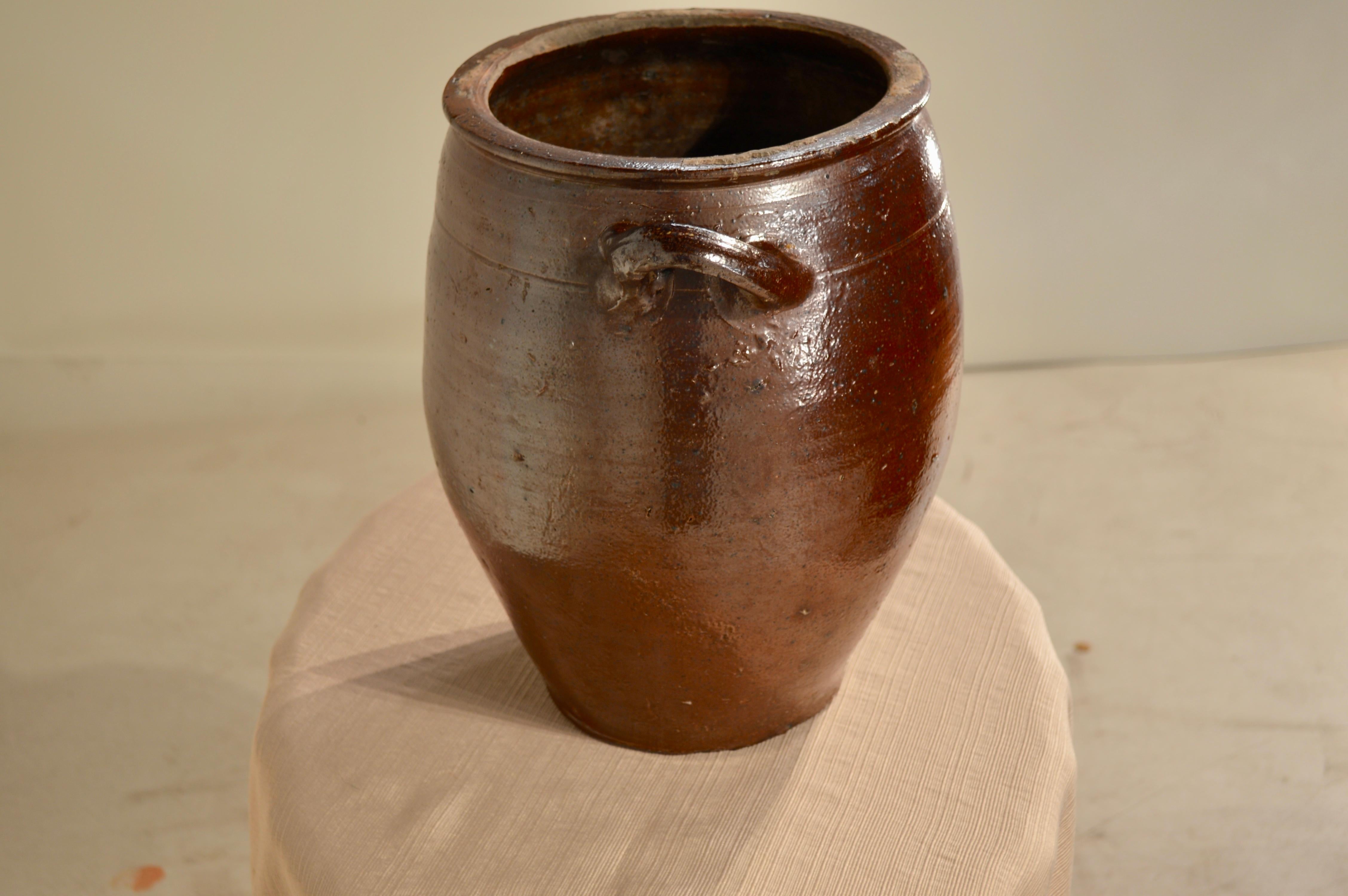 19th century French crock 19th century French hand-thrown pottery crock with applied handles. Losses to glaze and chips around bottom rim from use.