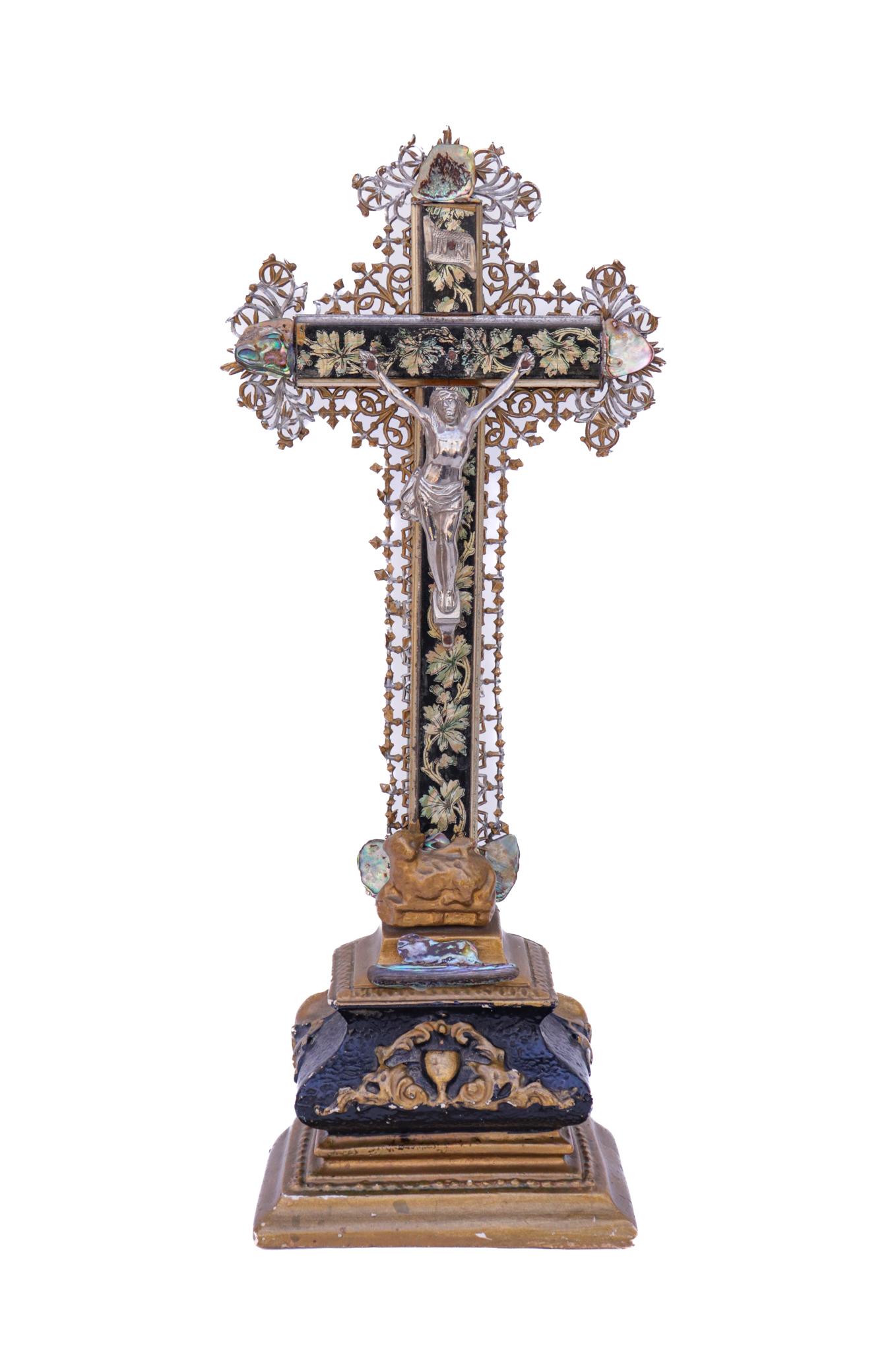 19th century French crucifix with metal filigree and a silver figure of Christ with abalone shells.

The piece has been hand-carved and painted and has the original silver figure of Christ. The abalone shells have been applied by Jean O'Reilly