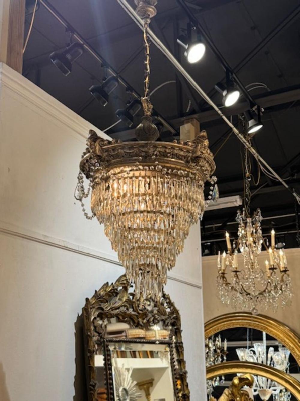 Elegant 19th century crystal and silver-plated brass waterfall chandelier. Featuring 6 tiers of cascading glistening crystals. Lovely!! This chandelier comes with a chain and canopy and is wired and ready to hang.