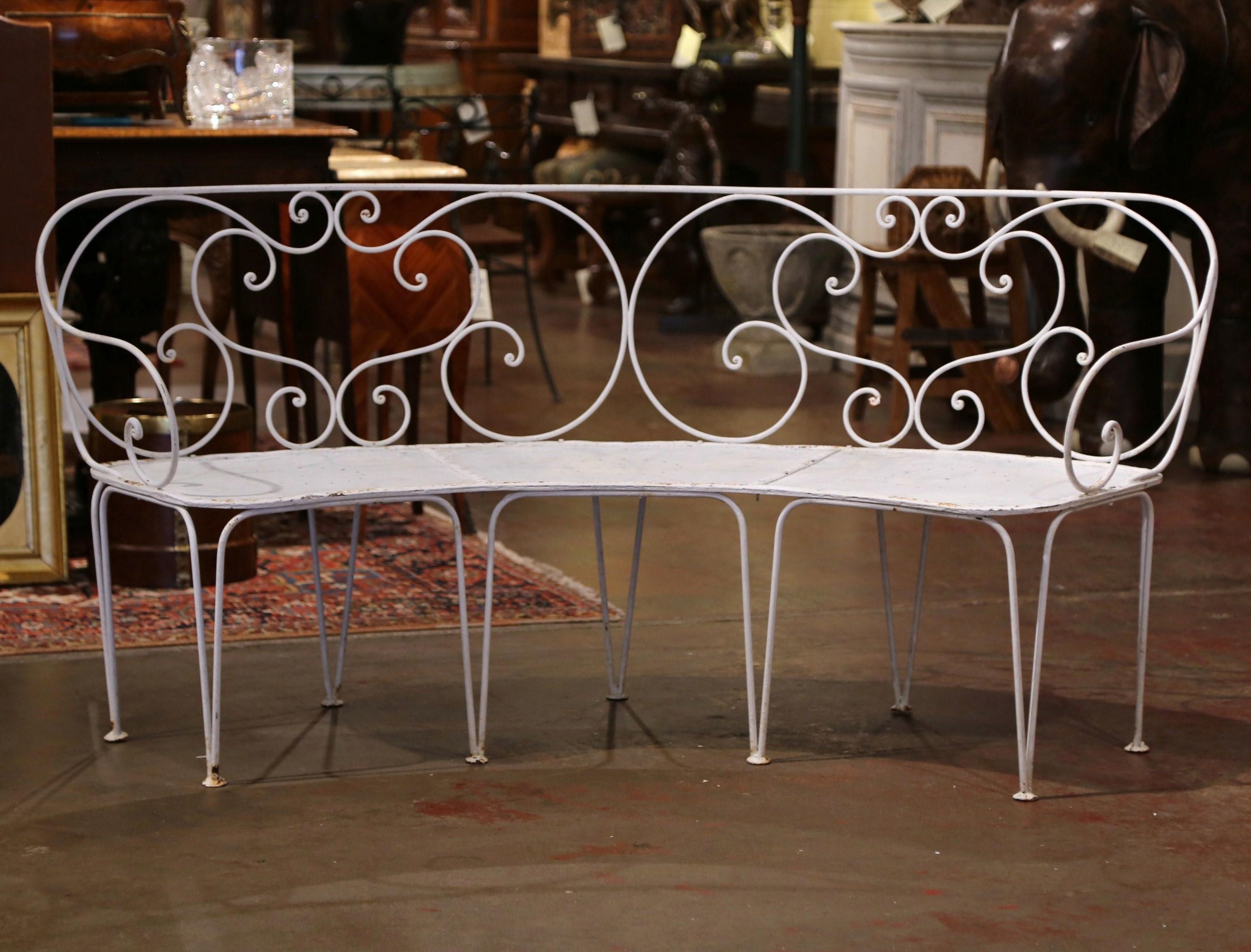 Add extra seating to an outdoor space, porch or patio with this elegant antique iron bench. Crafted in northern France circa 1880, the curved bench sits on nine thin tapered legs and could accommodate three people. The delicate garden bench has