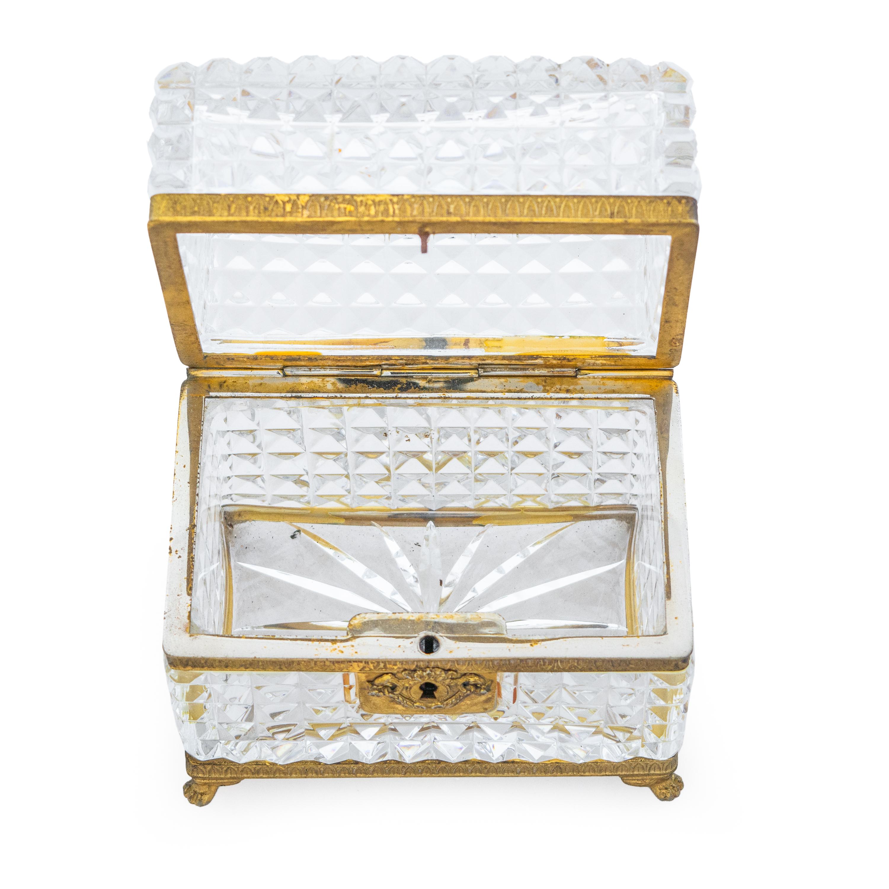 This is a Classic French Baccarat style cut glass box with brass trim and hinged lid, supported by small splayed feet, 19th century.