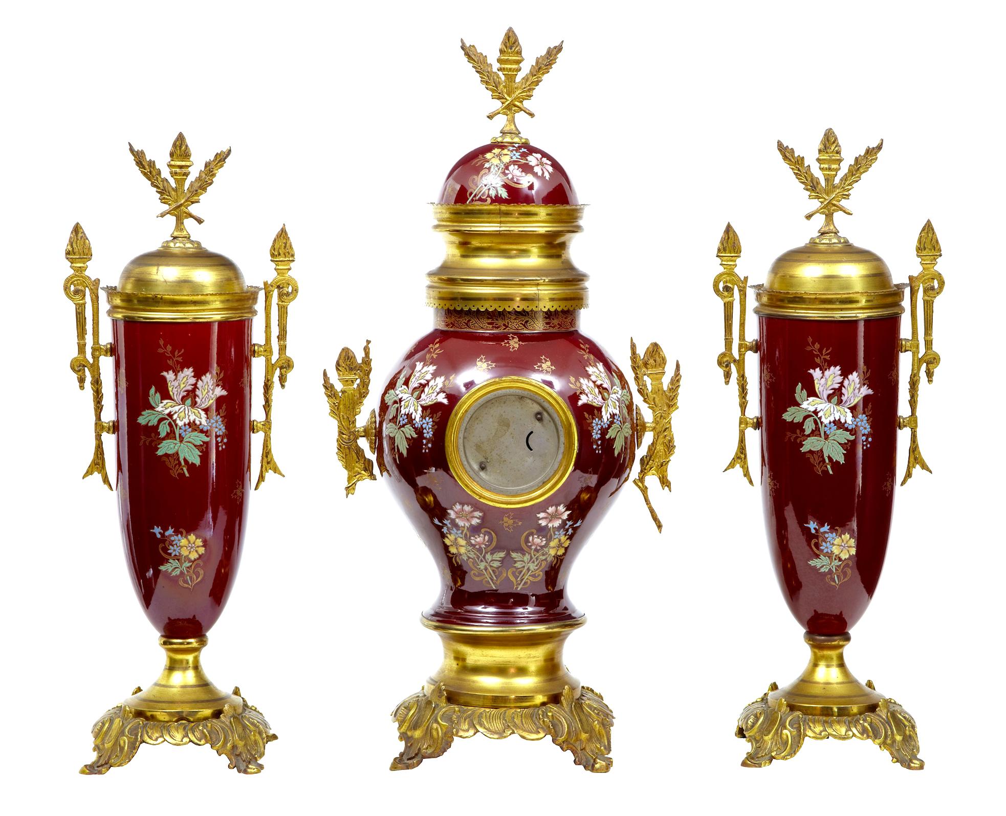 19th century French decorative toleware garniture set, circa 1880.

Fine example of a 3 piece garniture set, hand painted toleware decorated with ornate Ormolu mounts. Clock fitted with Arabic numerals.

Some discoloration to Ormolu.