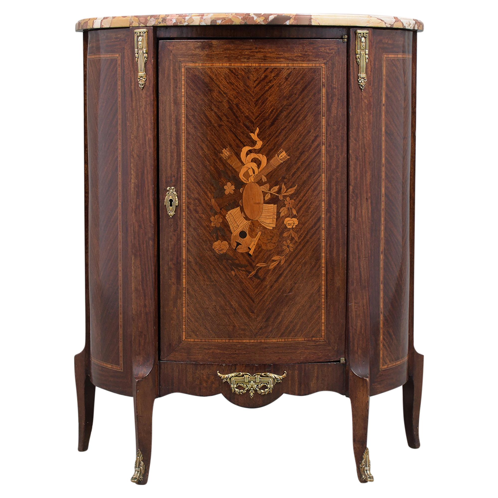 An elegant 19th century French Louis XVI small commode hand-crafted out of mahogany wood, this lovely piece features a bevel marble top in great condition and its original mahogany color finish newly waxed and polished developing a beautiful patina
