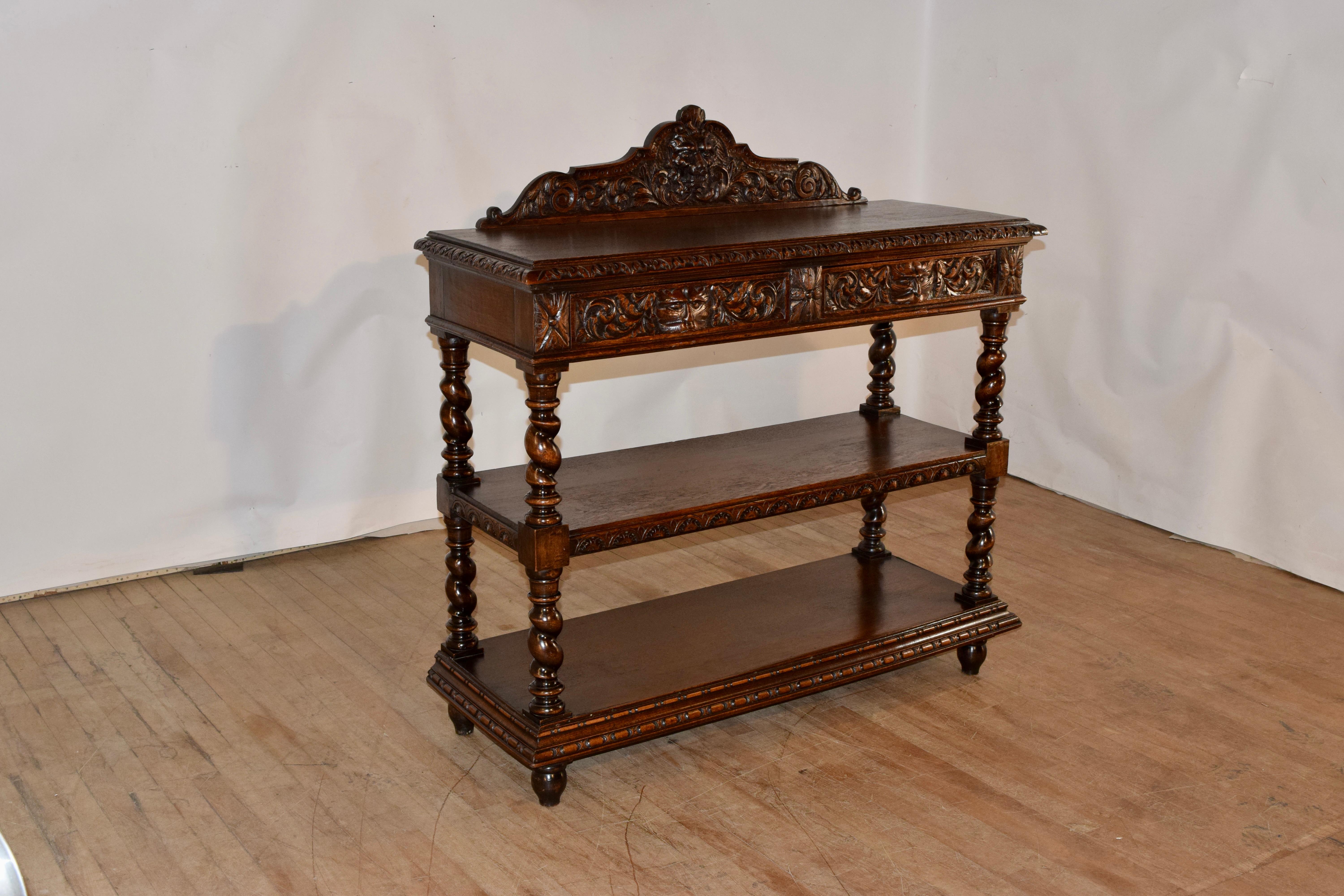19th century oak dessert buffet from France with a lovely detailed hand carved and scalloped backsplash, over three shelves. The top is wonderfully grained and has a hand beveled and carved decorated edge. The sides are simple and the front apron
