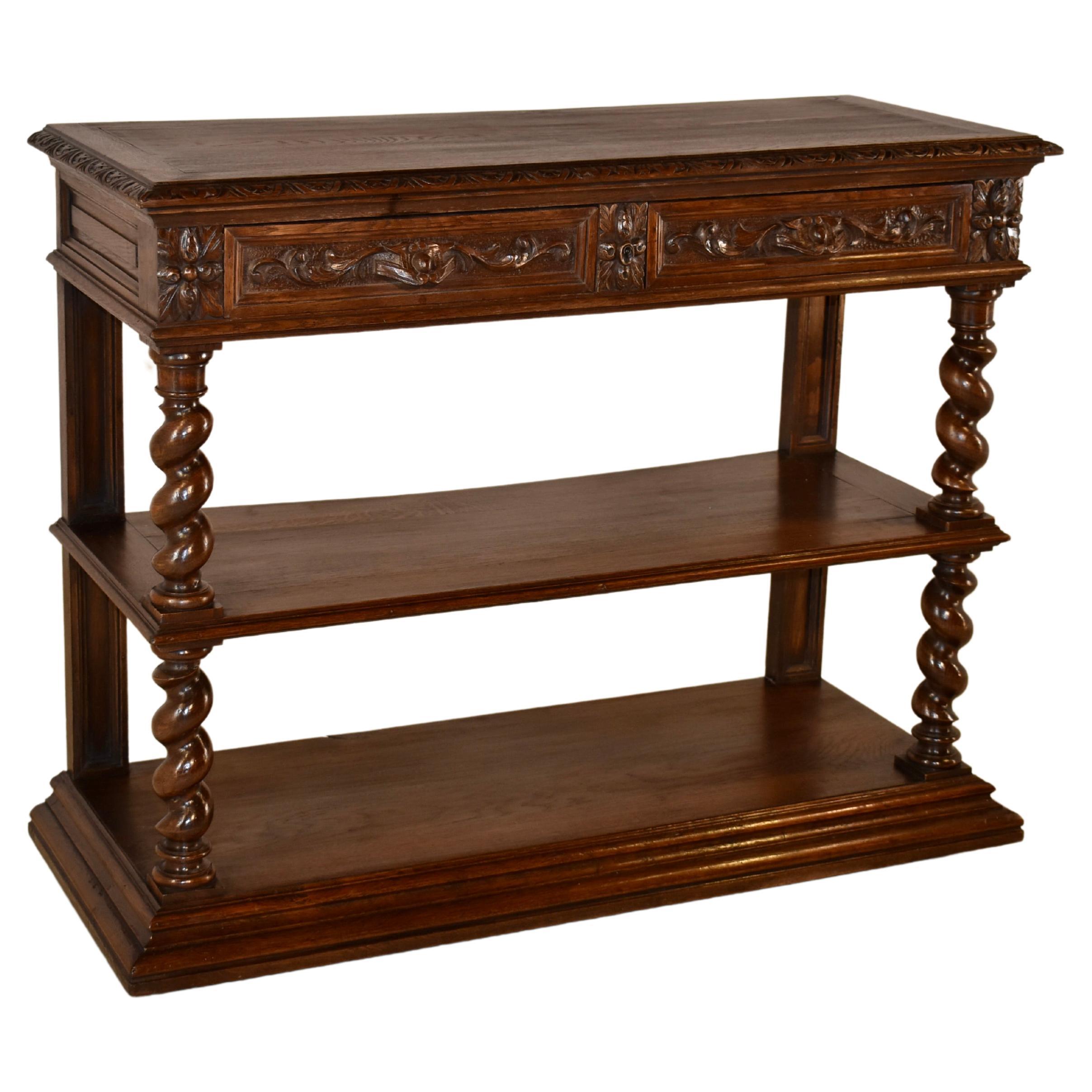 19th century oak dessert buffet from France. The top is banded and has a beveled and carved decorated edge around the top in a nulled pattern. The top lifts to reveal a marble surface for serving which remains open with a scalloped bracket. The top