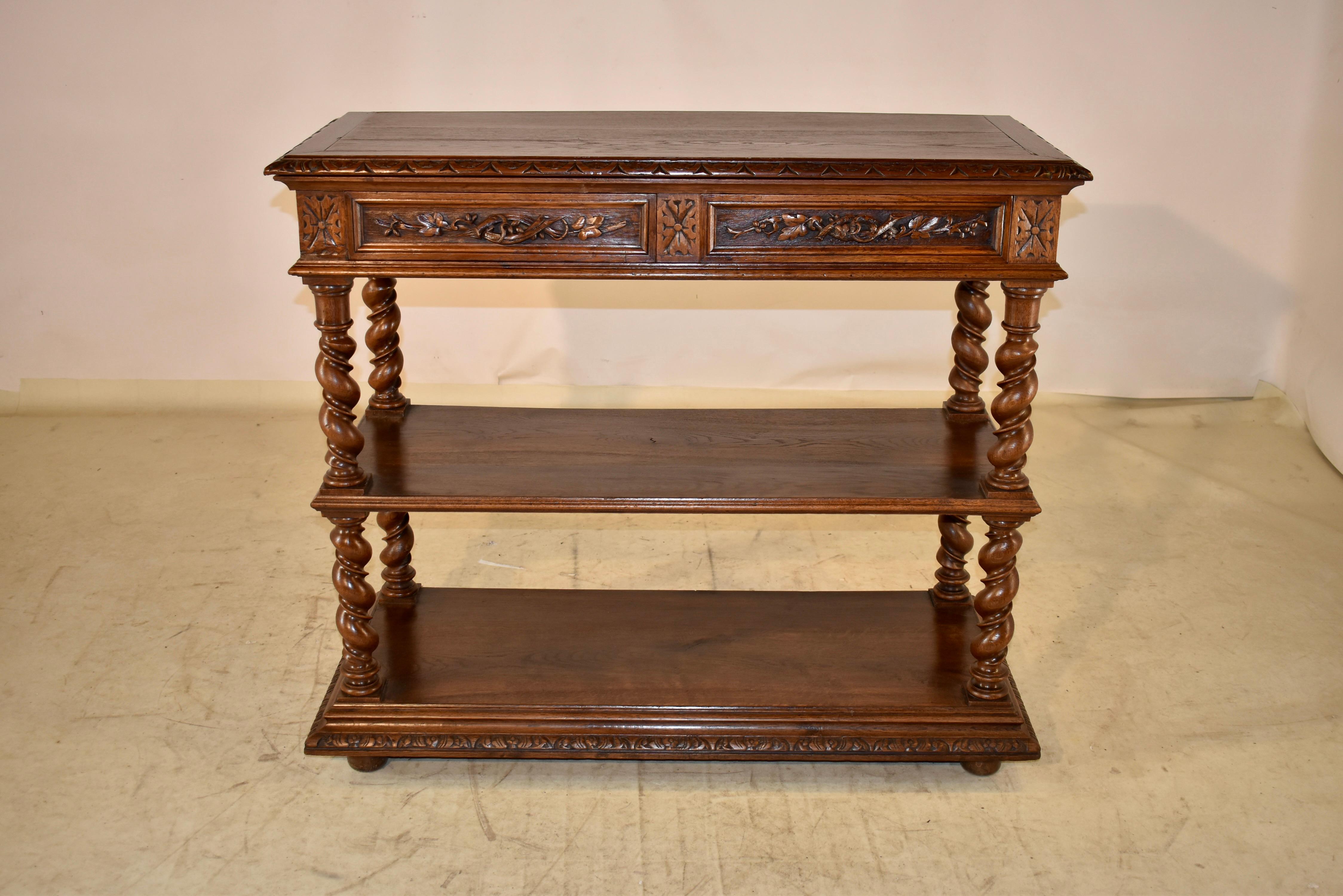 19th century oak dessert buffet from France.  The top is banded and has a beveled and hand carved decorated edge.  The top then lifts to reveal a marble serving surface, which is held up by a bracket.  The top is over hand carved paneled sides, and