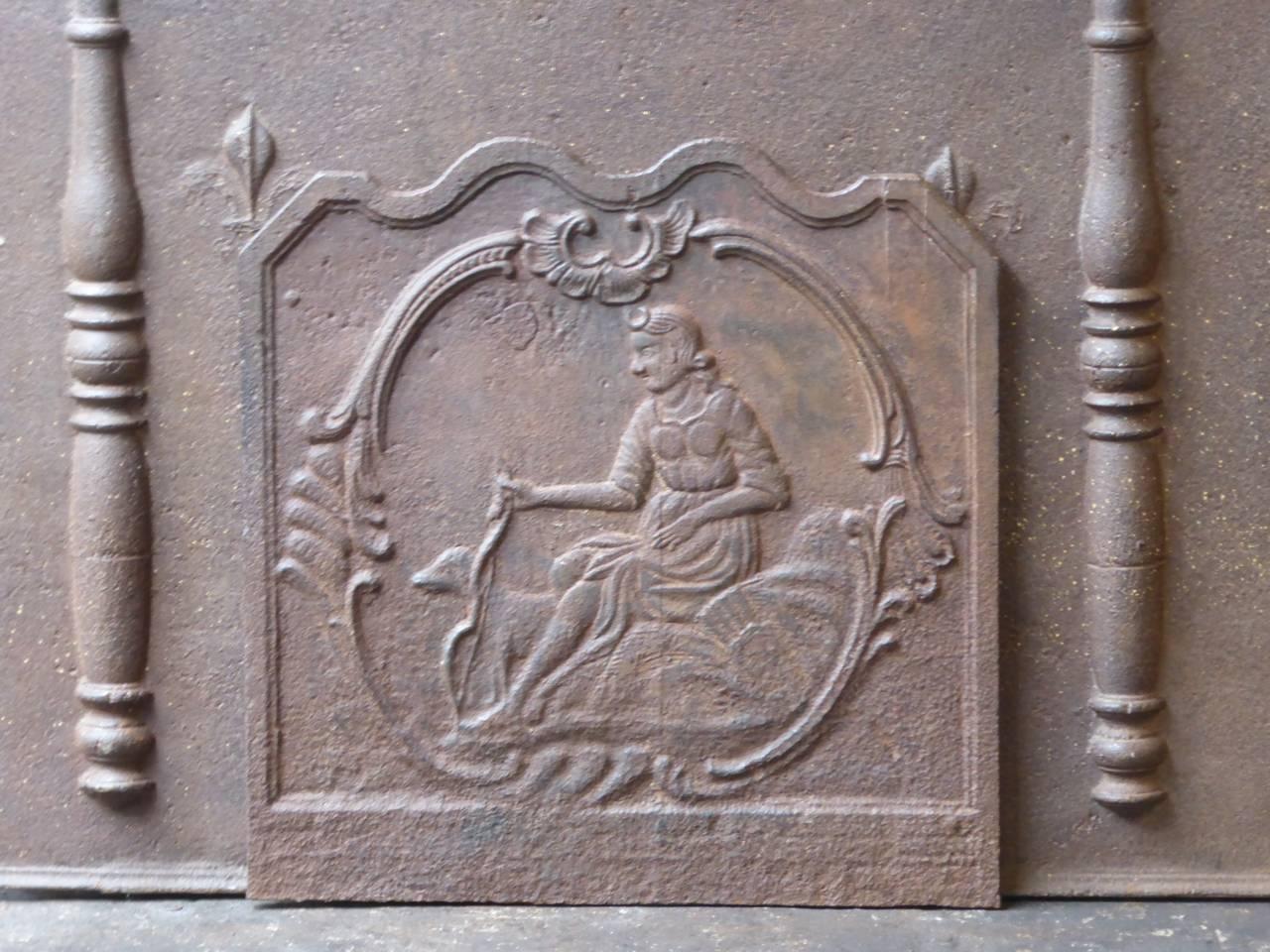 19th century French fireplace fireback with the goddess Diana. Goddess of hunting, also protector of animals of the forest, especially the young animals. She experienced great pleasure in hunting, but took care that she did not kill more animals