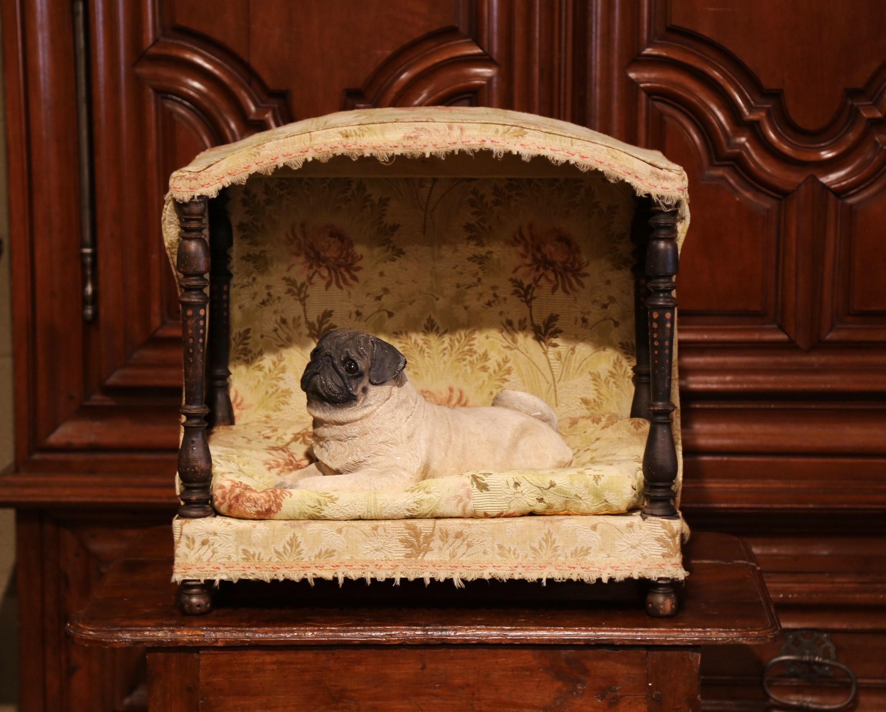 Give your dog or cat a spoiled and lavish lifestyle in this antique dog house. Crafted in France circa 1810, the bed features an arched top and four hand carved turned posts in each corner. The bed has its original removable sleeping cushion and
