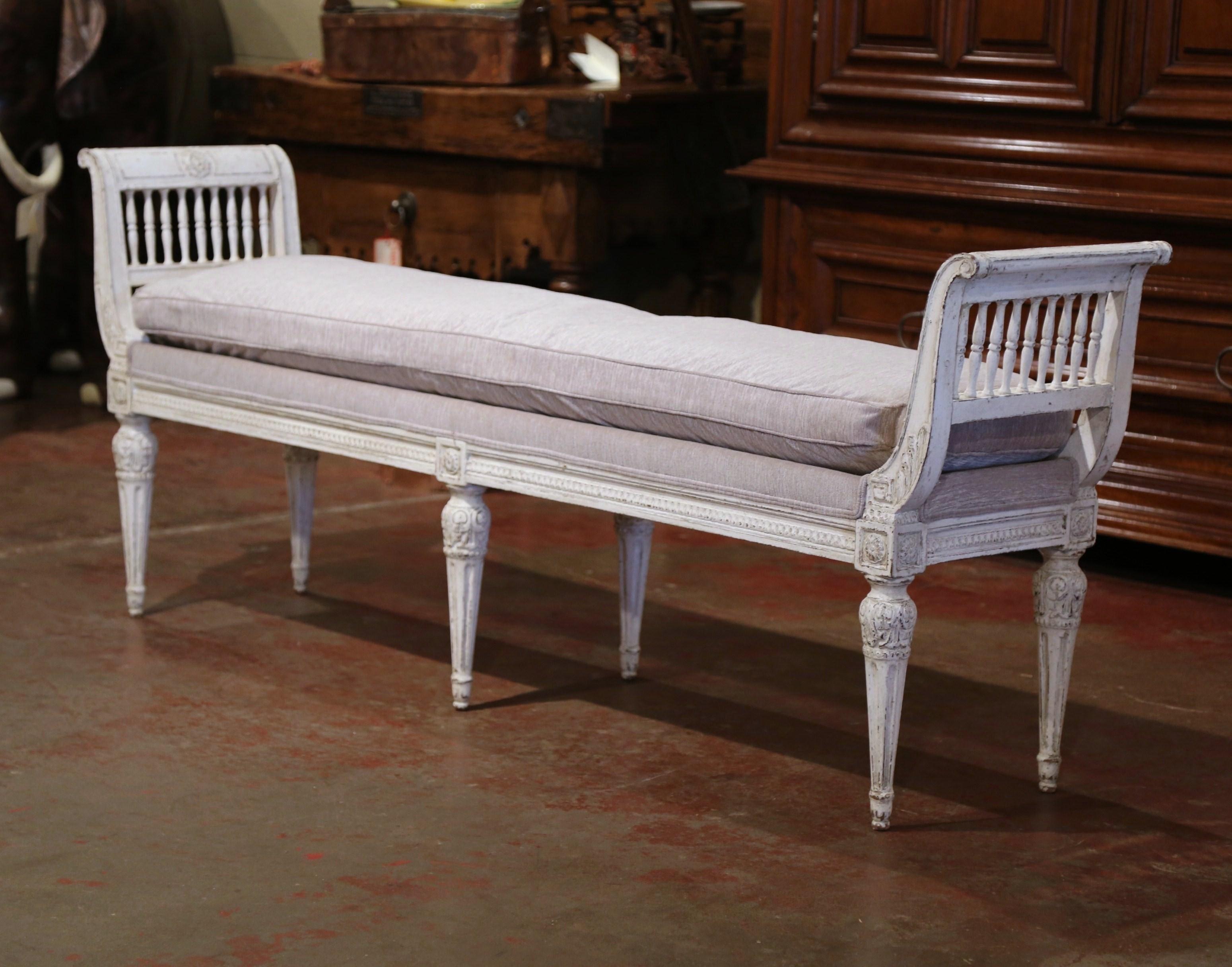 Place this elegant antique six-leg bench at the foot of a king size bed or in your living room for extra, versatile seating. Crafted in France, circa 1890, the traditional banquette stands on six tapered and fluted legs embellished with carved