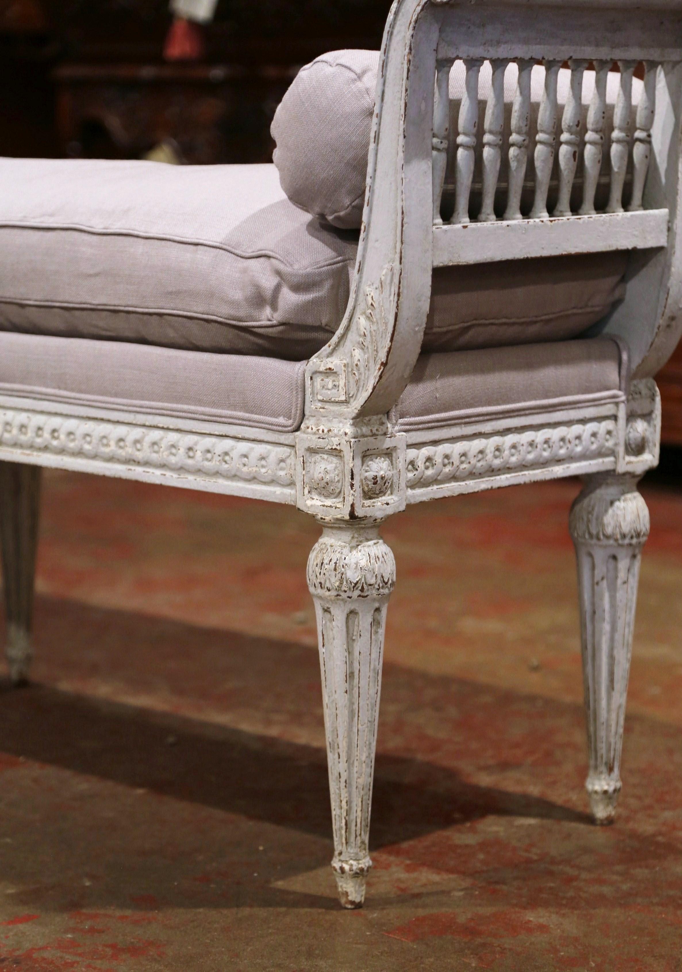 Place this elegant antique six-leg bench at the foot of a king size bed or in your living room for extra, versatile seating. Crafted in France, circa 1880, the traditional banquette stands on six tapered and fluted legs embellished with carved
