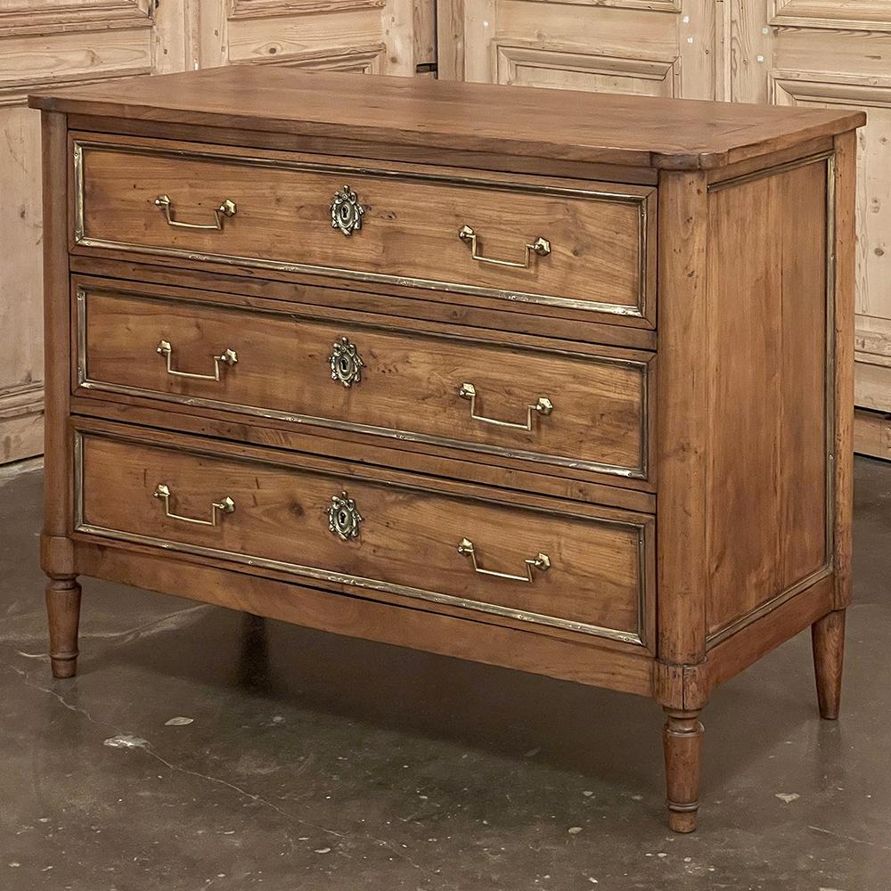 19th Century French Directoire Cherry Wood Commode exudes the understated elegance for which the style is world renowned!  Crafted from old growth seasoned cherry wood to produce a rich, warm tone that is conducive to blending with most any decor,
