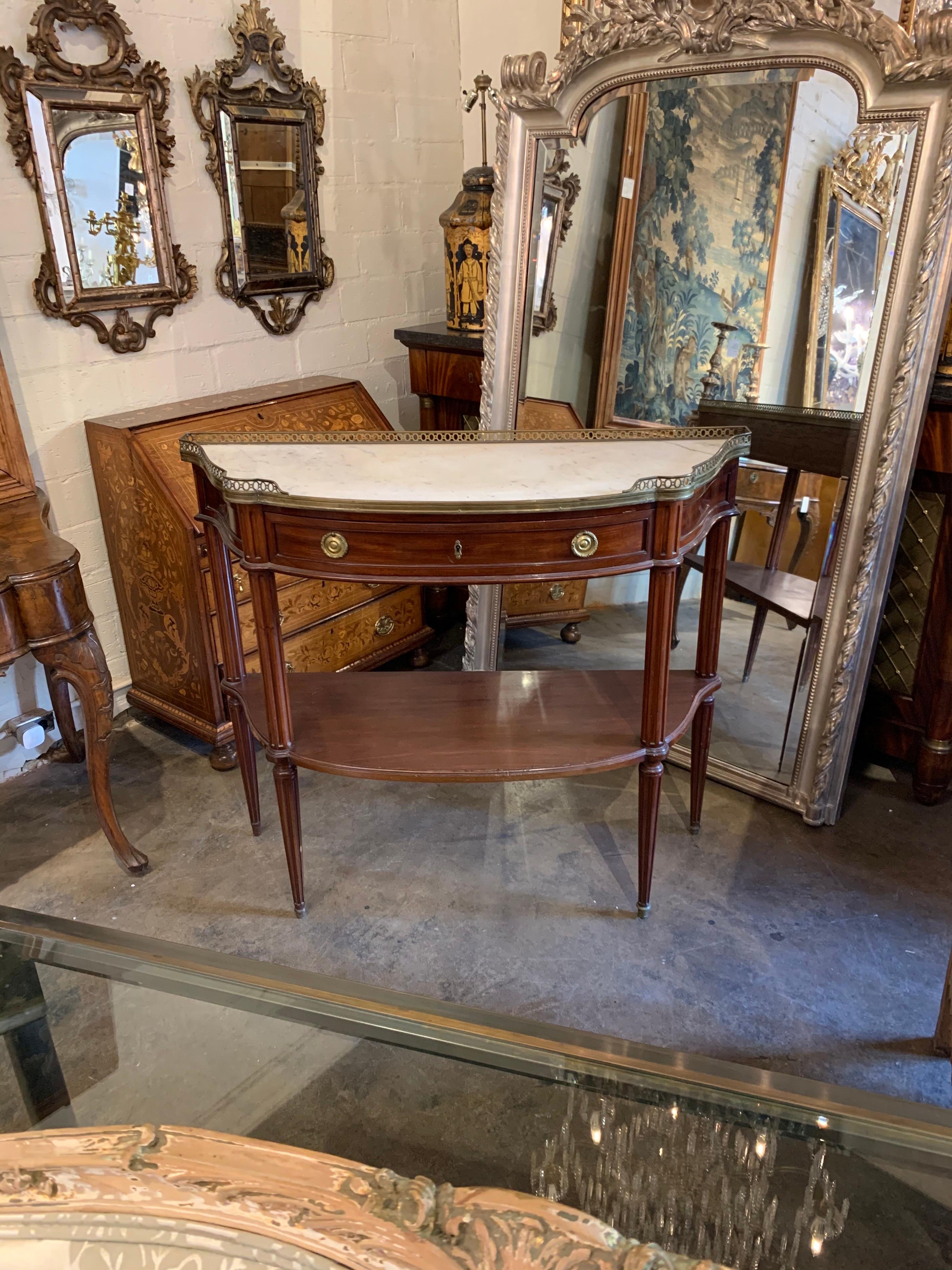 Classic 19th century French Directoire mahogany console with beautiful Carrara marble top. Very fine polished wood and pretty hardware. A lovely design element!
Note the height, this console is taller than most.