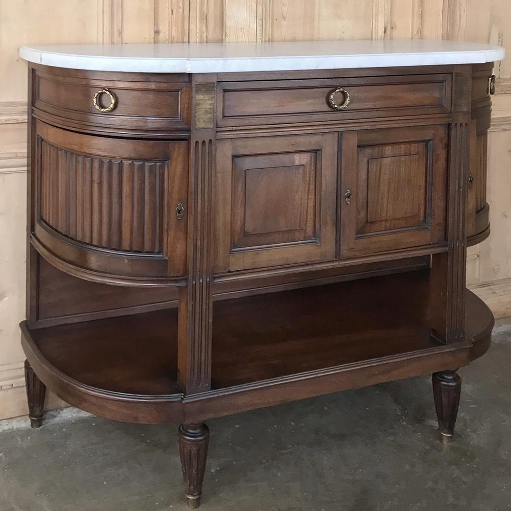 19th century French Directoire mahogany marble top buffet is the perfect choice for those desiring just a touch of formality without a fussy look! Handcrafted from exotic imported mahogany and featuring a traffic-friendly rounded side design, it has
