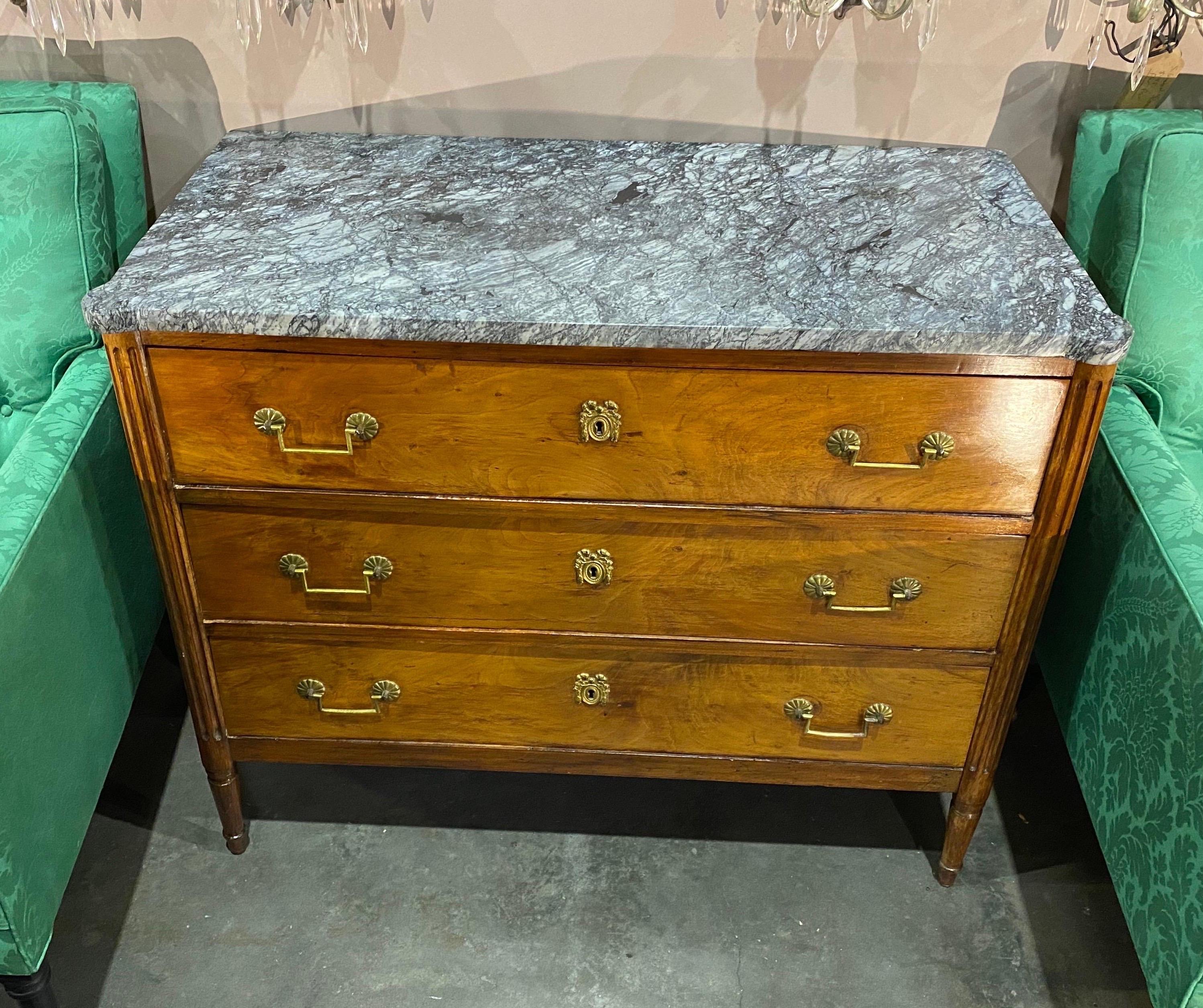 Gorgeous 19th century French Directoire marble top chest with rounded and fluted corners.