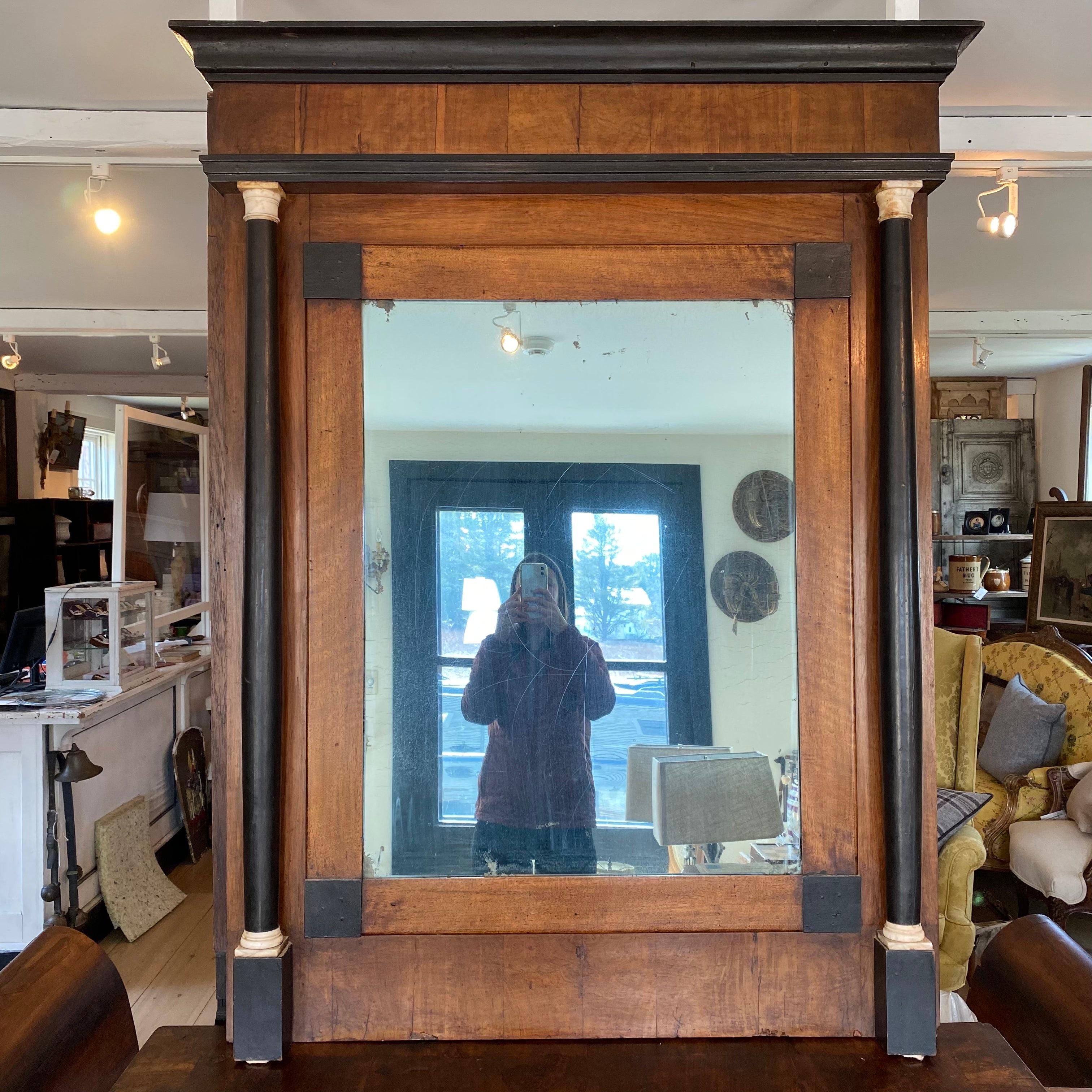 Stunning two piece French Directoire mirror over matching console, perfect for an entryway or important hallway. Mirror has original stunning mirror glass in framed walnut base, with ebony molding and ebony columns on either side of the mirror, as
