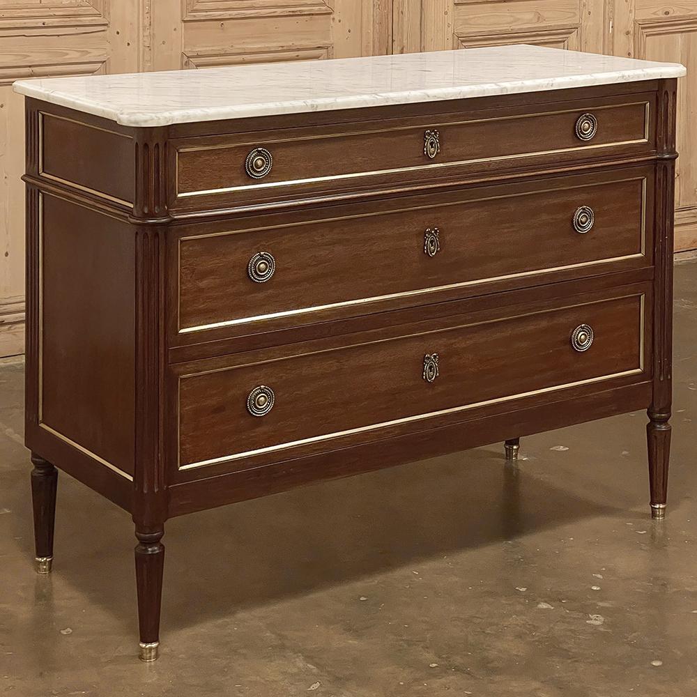 19th Century French Directoire Neoclassical mahogany marble top commode is a superlative example of the genre! The style was born in the early years of the 19th century when Europe was in a particularly tumultuous state. The Directoire which was