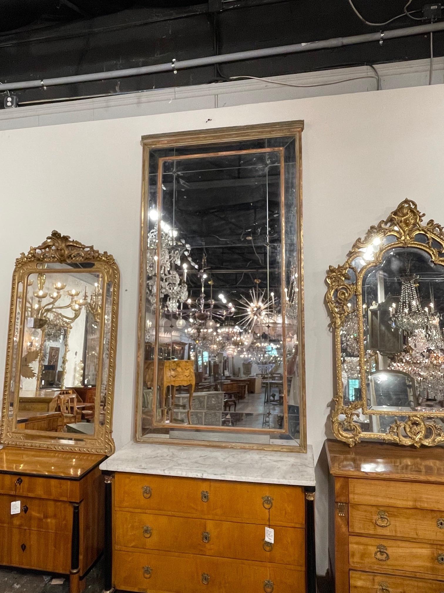 Superb large scale 19th century French Directoire period mirror with original divided mercury glass. Creates a beautiful presence. Very special!